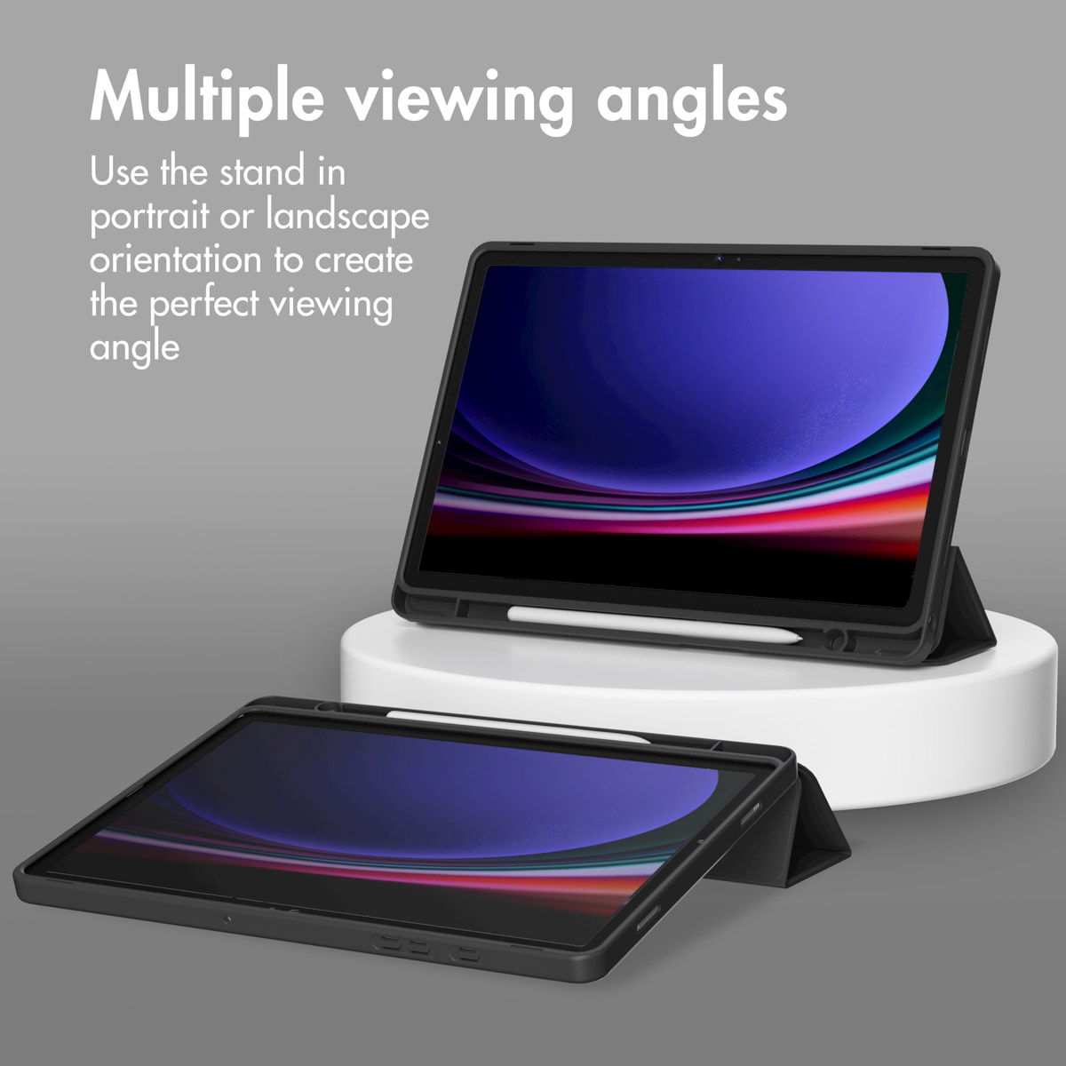 Two black tablets in protective cases, one upright on a white platform and one lying flat with a stylus.