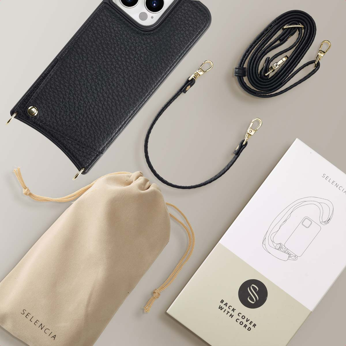 Coque de téléphone noire avec sangles, pochette et boîte.