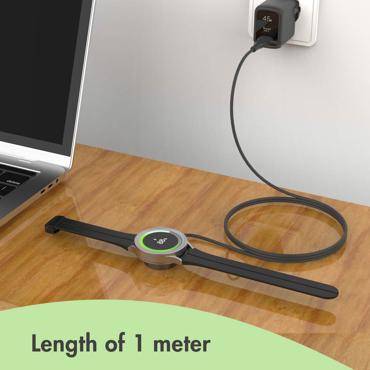 A smartwatch lies on a wooden desk, charging with a cable plugged into a wall adapter next to a laptop.