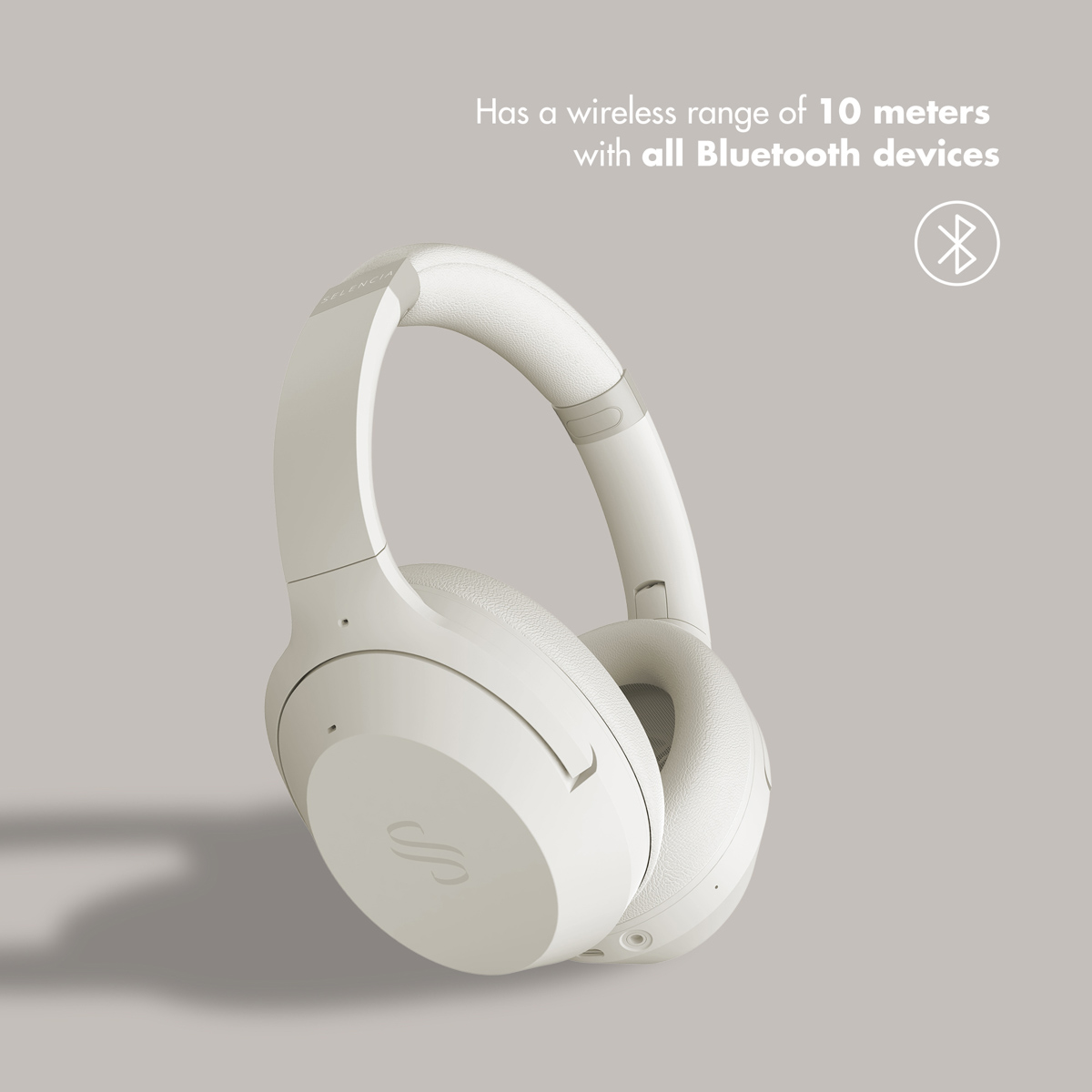 Kremowe słuchawki wokółuszne o zasięgu Bluetooth 10 metrów.