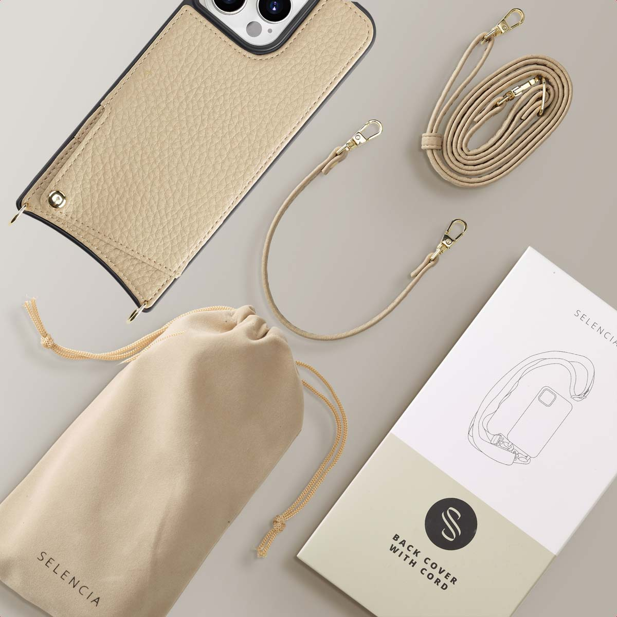 Coque de téléphone beige avec lanière, pochon et emballage sur fond clair.