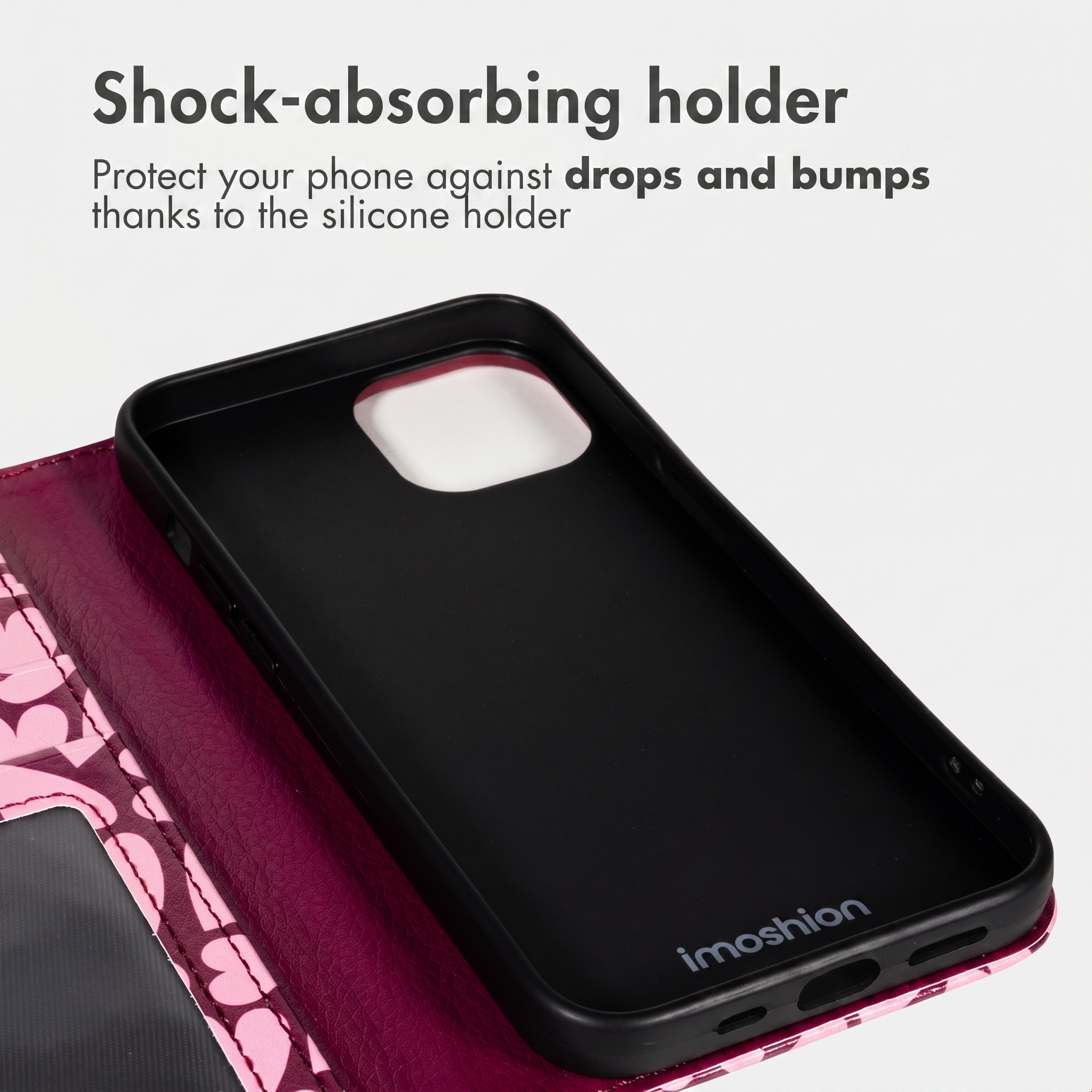 Roze kunstlederen telefoonhoesje met zwarte siliconen houder en tekst over schokabsorptie.