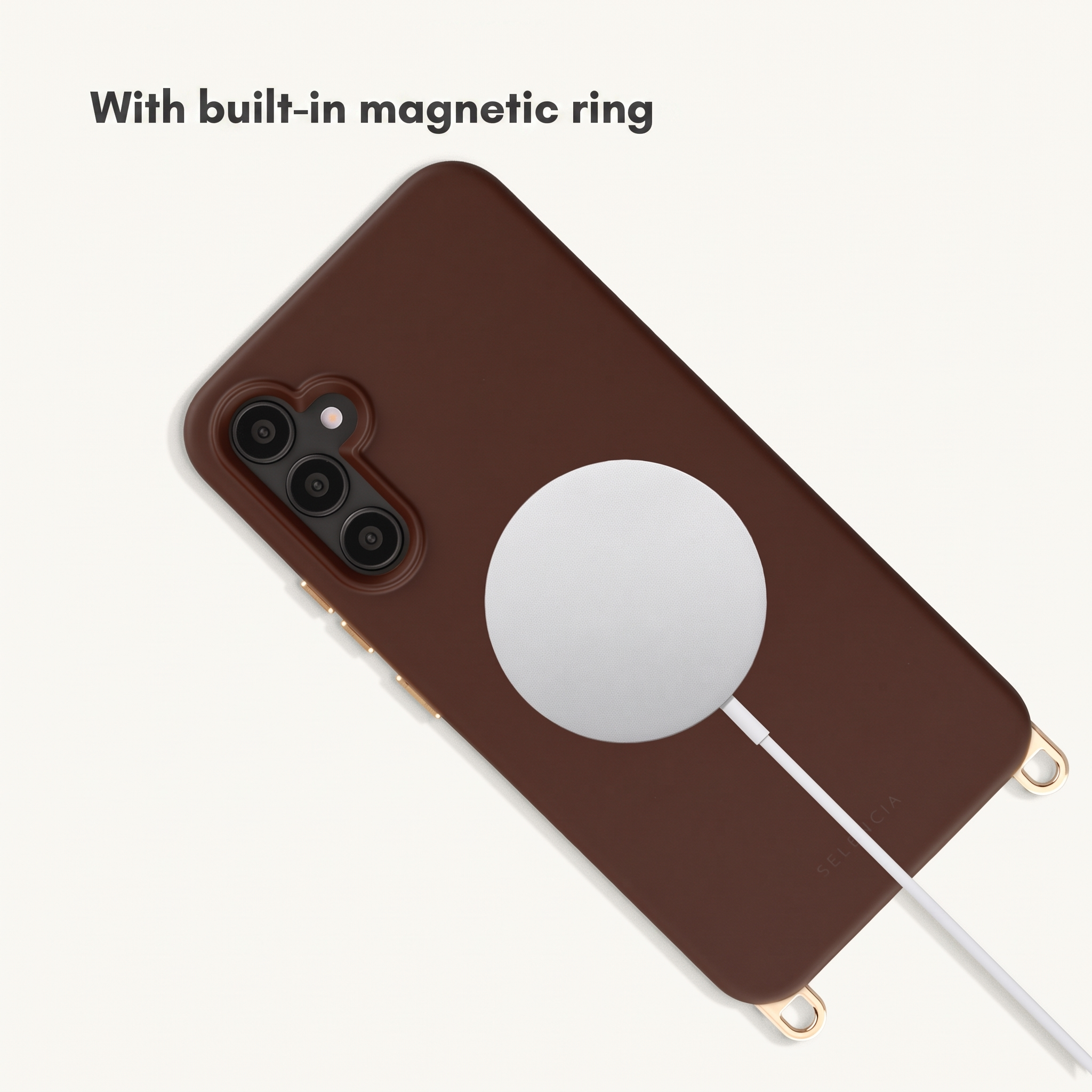 Funda de teléfono marrón con anillo magnético integrado y cable de carga blanco.