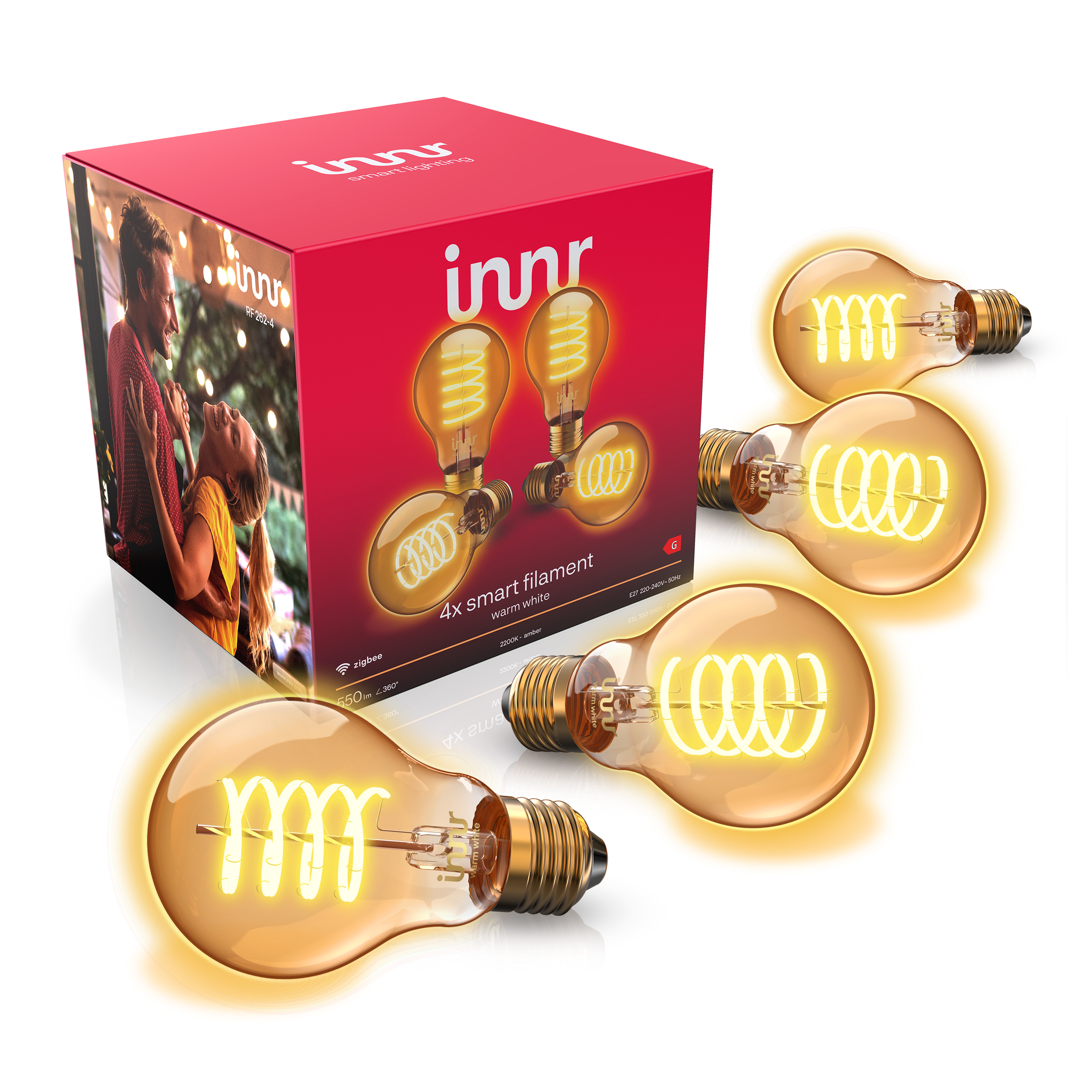 Quatre ampoules LED à filament intelligentes avec lumière chaude devant une boîte rouge Innr.
