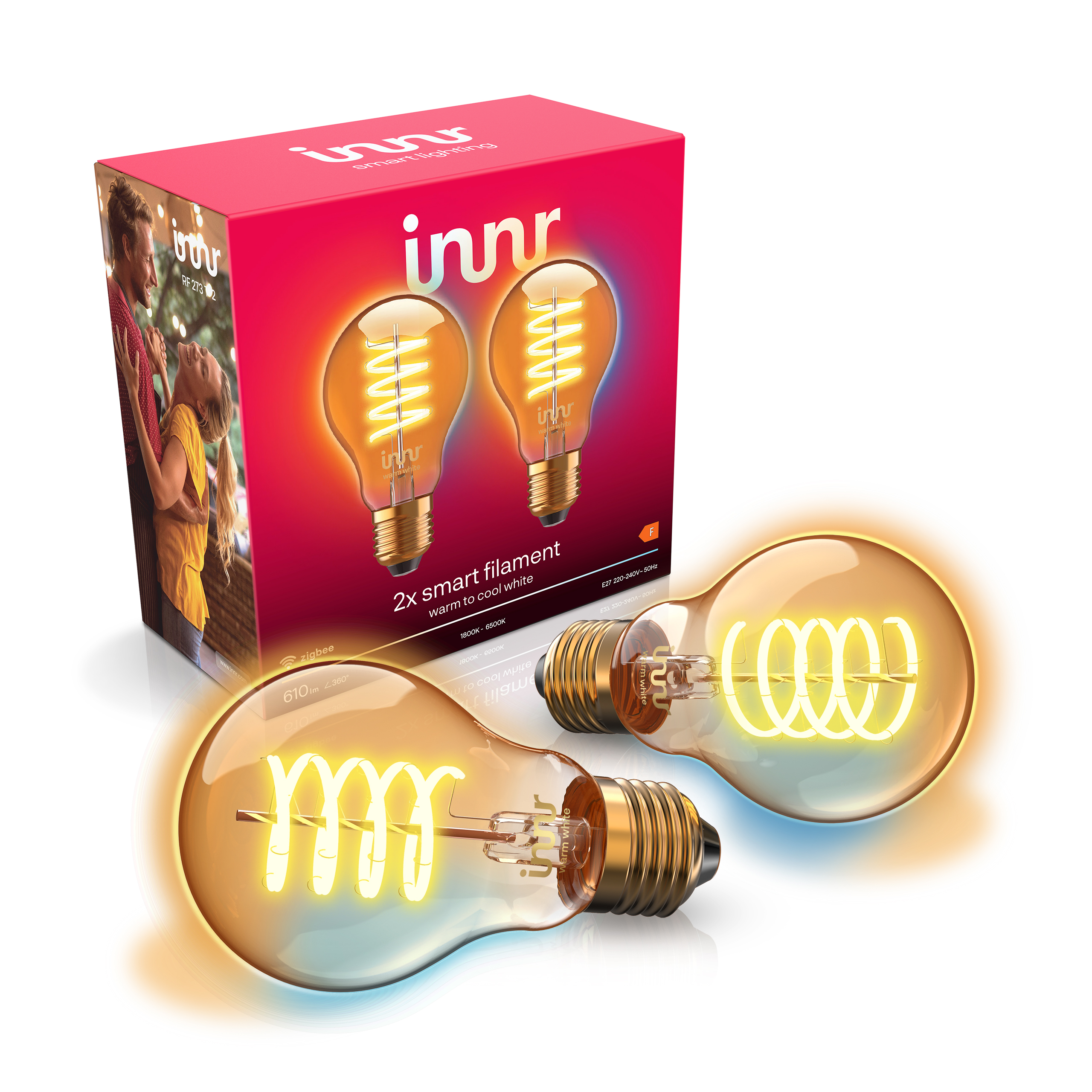 Deux ampoules LED à filament ambré disposées devant une boîte de produit rouge Innr avec des graphismes d'ampoules.