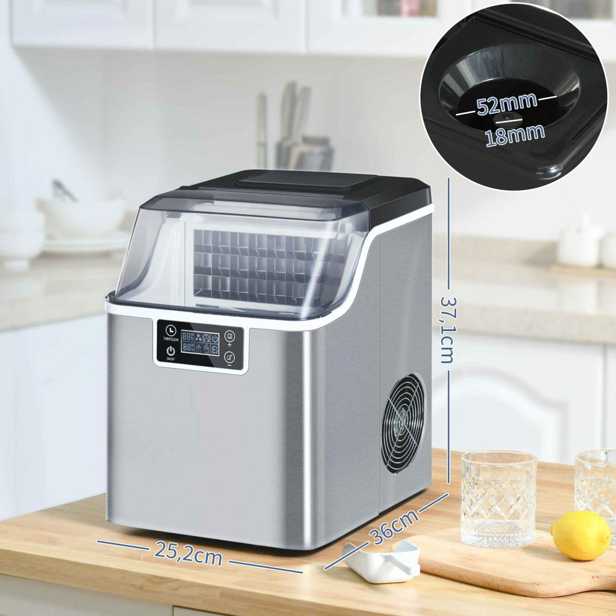 Edelstahl-Eiswürfelmaschine auf einer Küchentheke mit Maßen, Gläsern und einer Zitrone daneben.