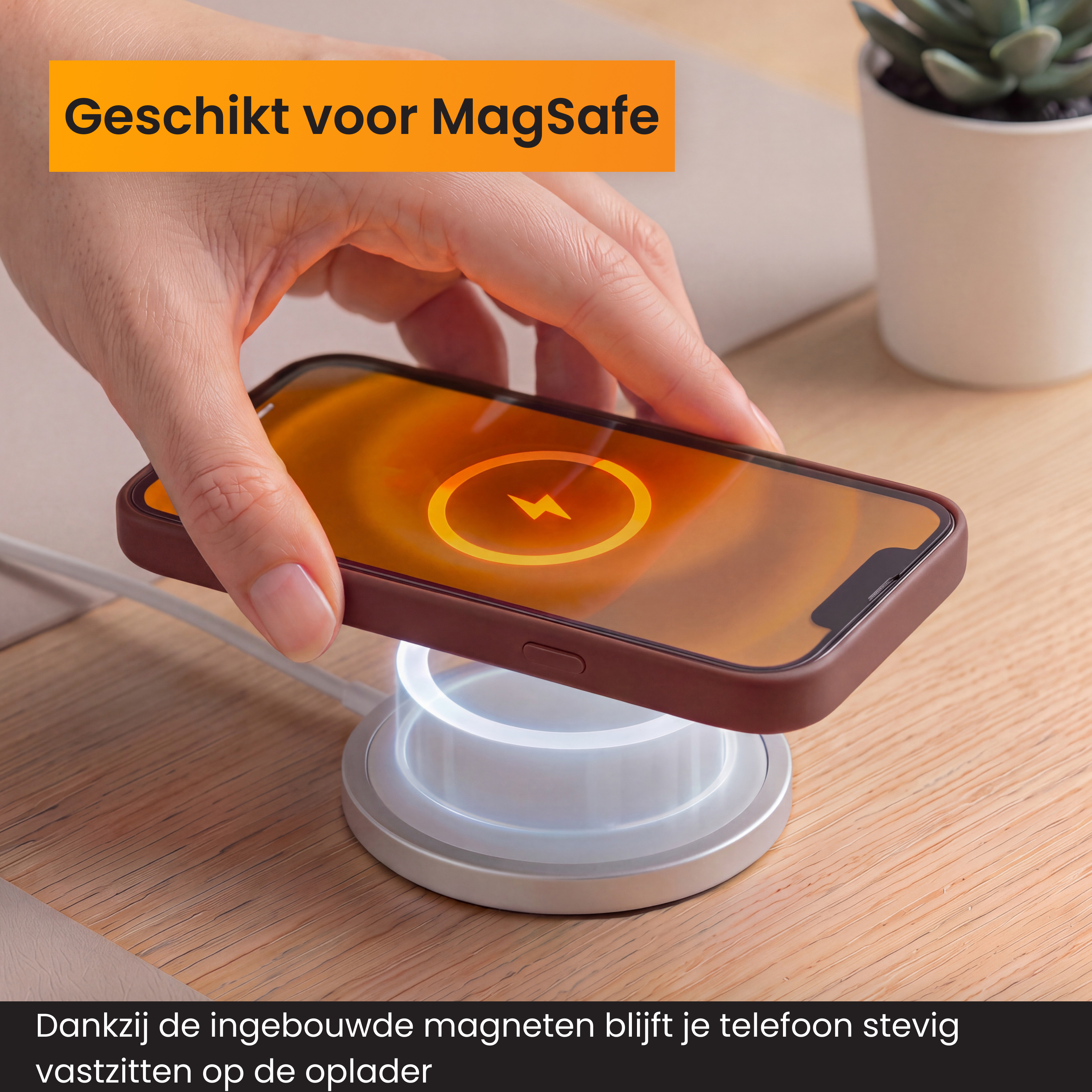 Hand plaatst een iPhone met oplaadicoon op een ronde MagSafe oplader op hout.