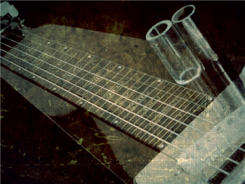 Ein Gitarrenhals mit Saiten und zwei transparente Glasröhrchen auf einem dunklen Hintergrund.