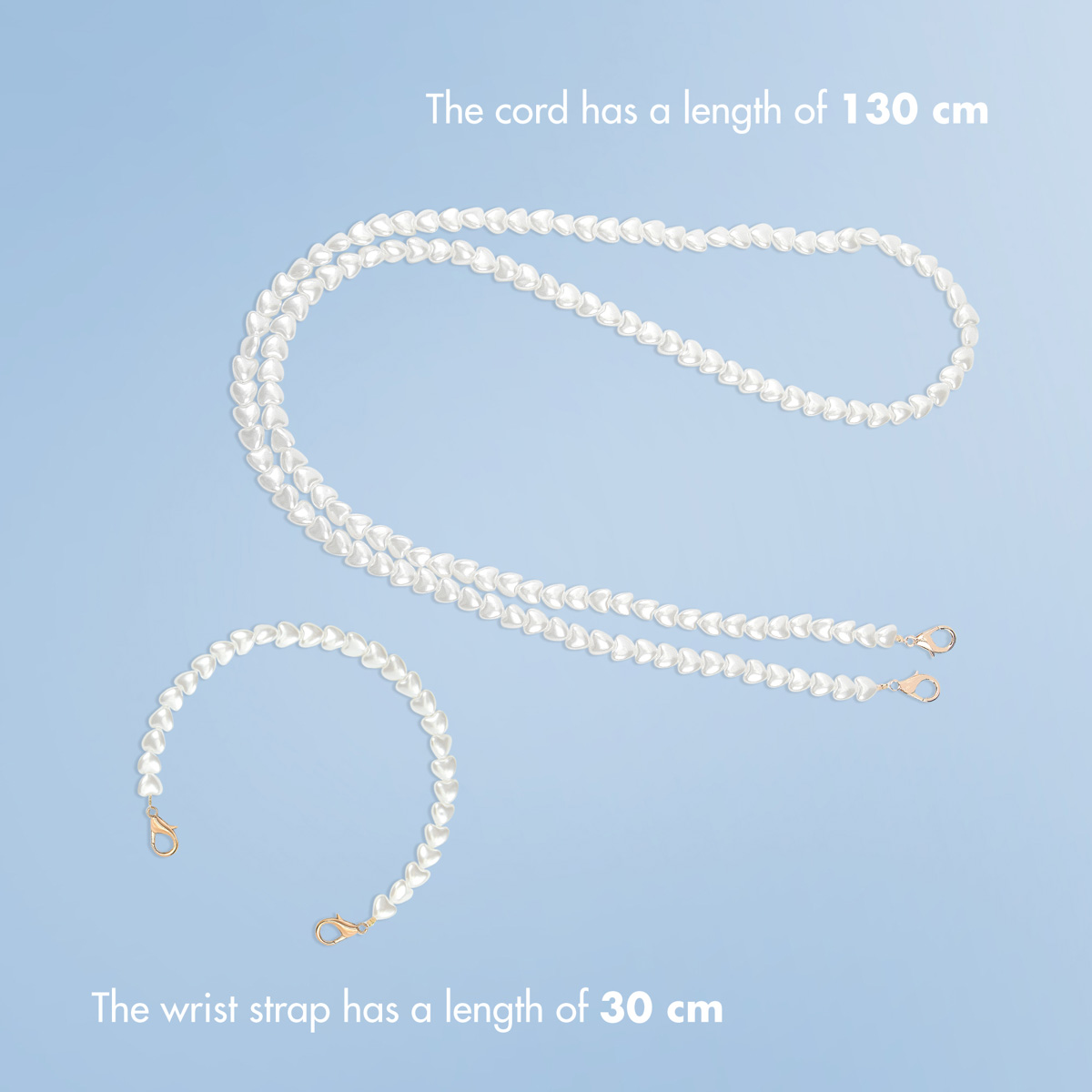Un long cordon et un bracelet plus court en perles blanches en forme de cœur avec fermoirs dorés.