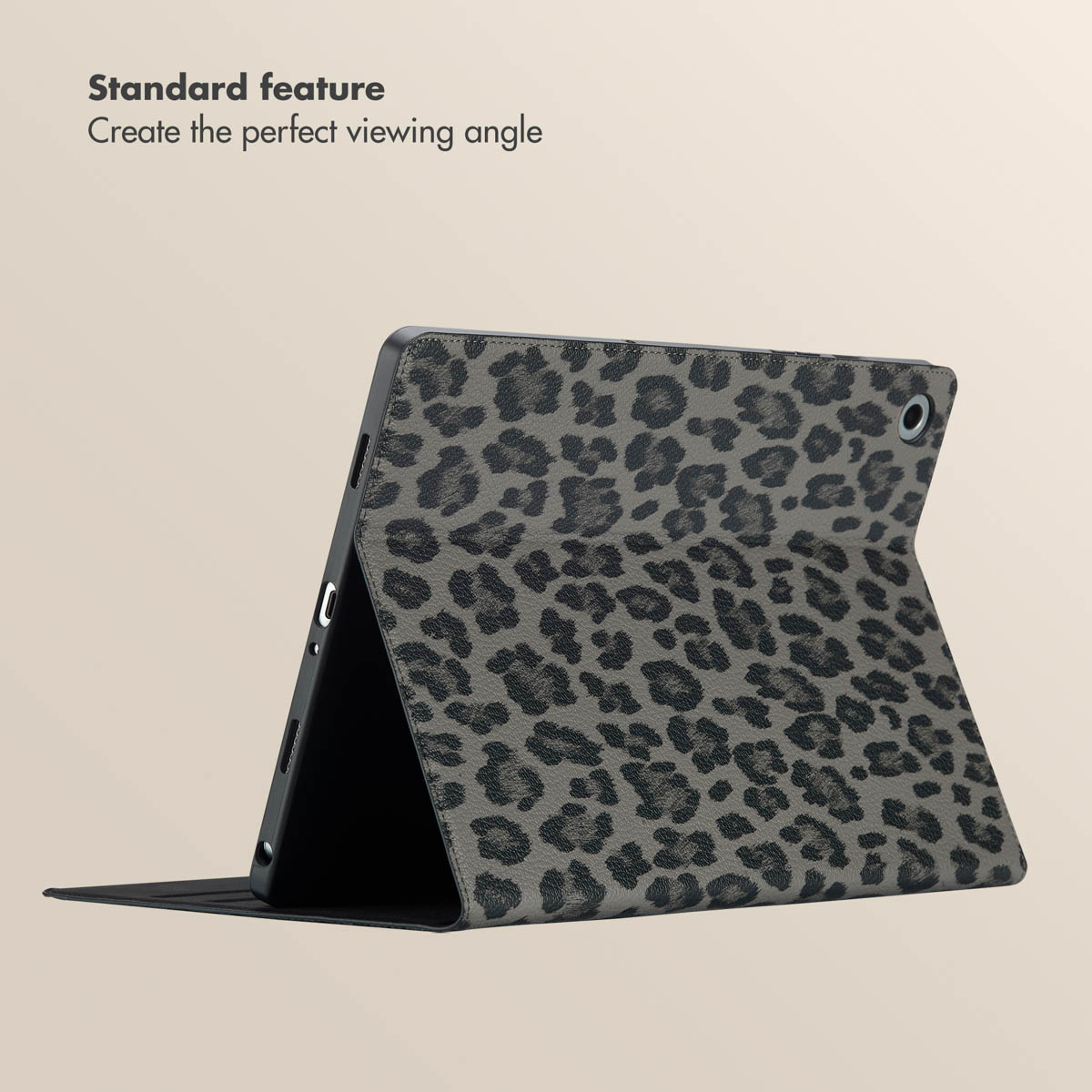 A gray tablet with a leopard print stands angled on a stand against a beige background.