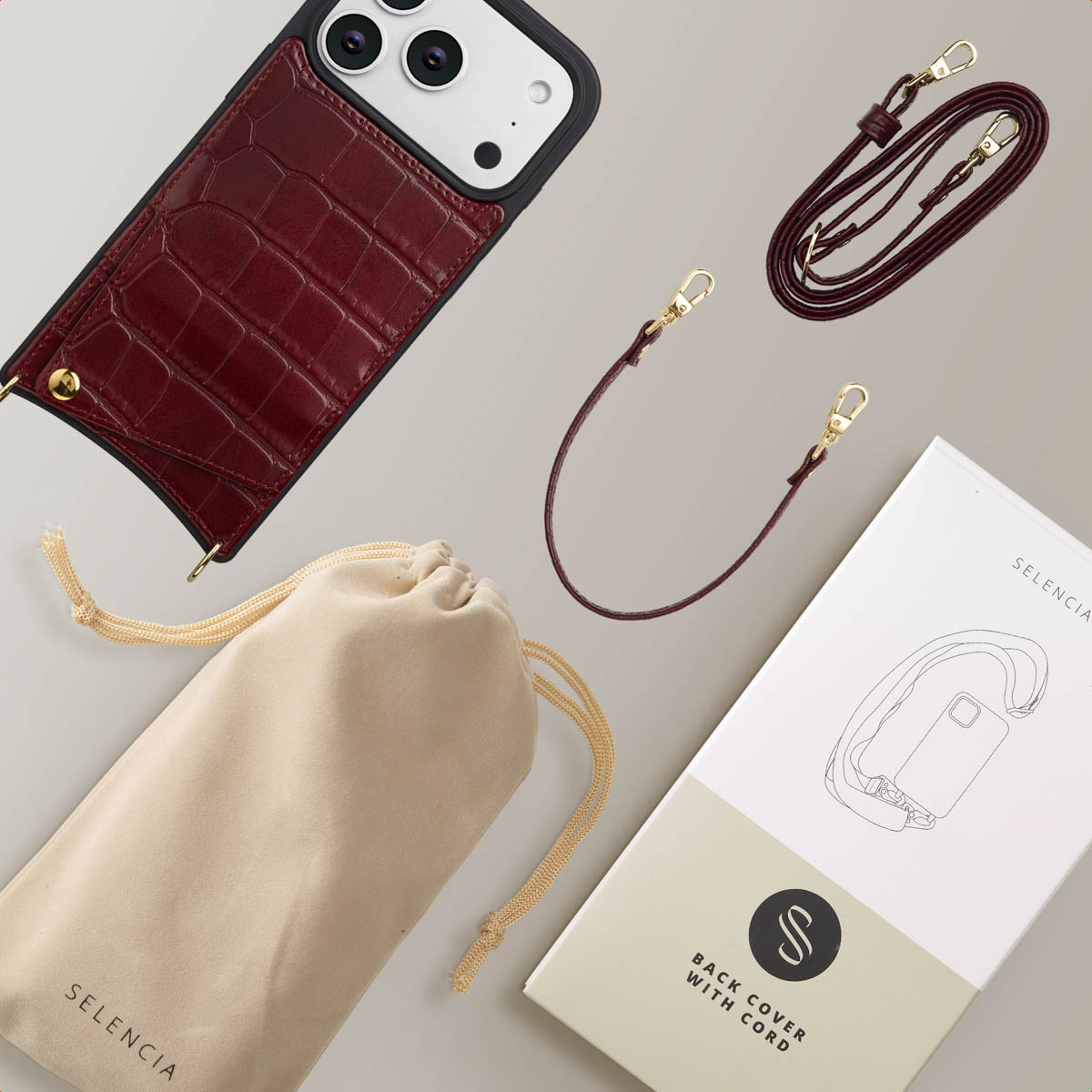 Funda de móvil burdeos con patrón de cocodrilo, dos correas, bolsa y caja.