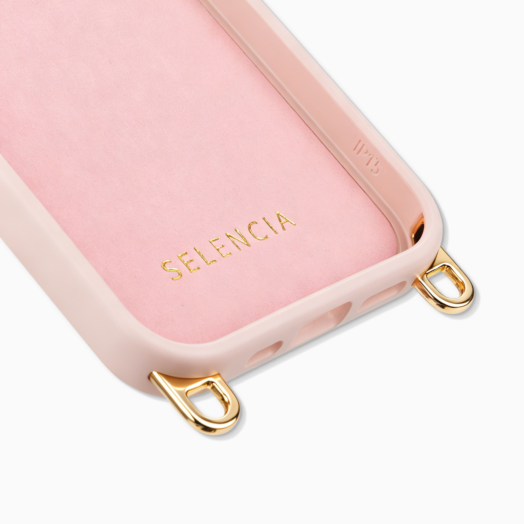 Roze telefoonhoesje met gouden ringen en de merknaam SELENCIA aan de binnenzijde.