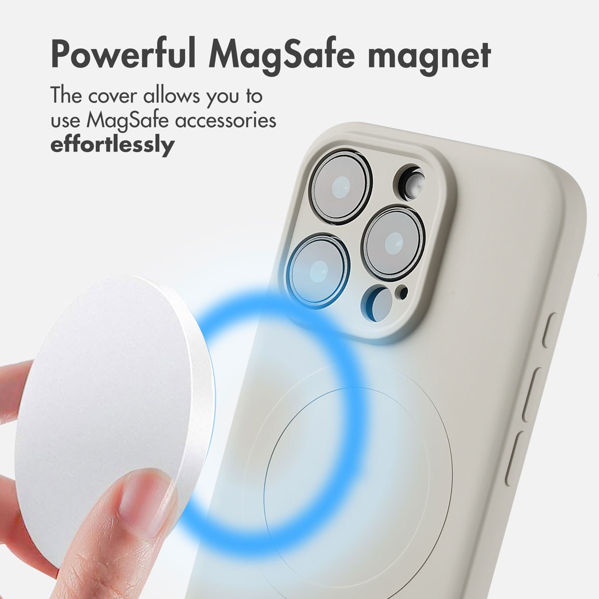 Une main tient un aimant rond près d'une coque beige sur un smartphone.