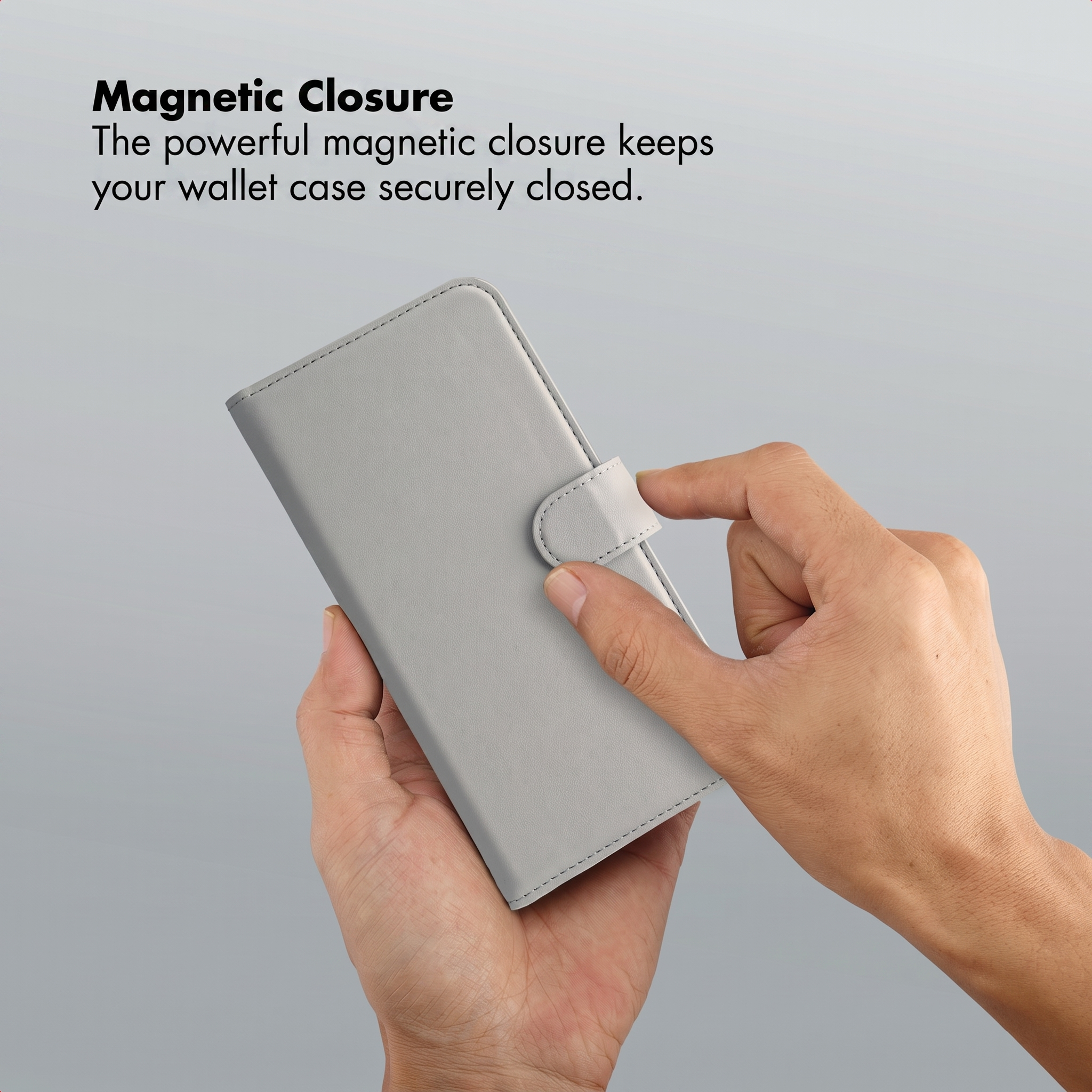 Hands holding a grey smartphone wallet case secured with a magnetic closure.