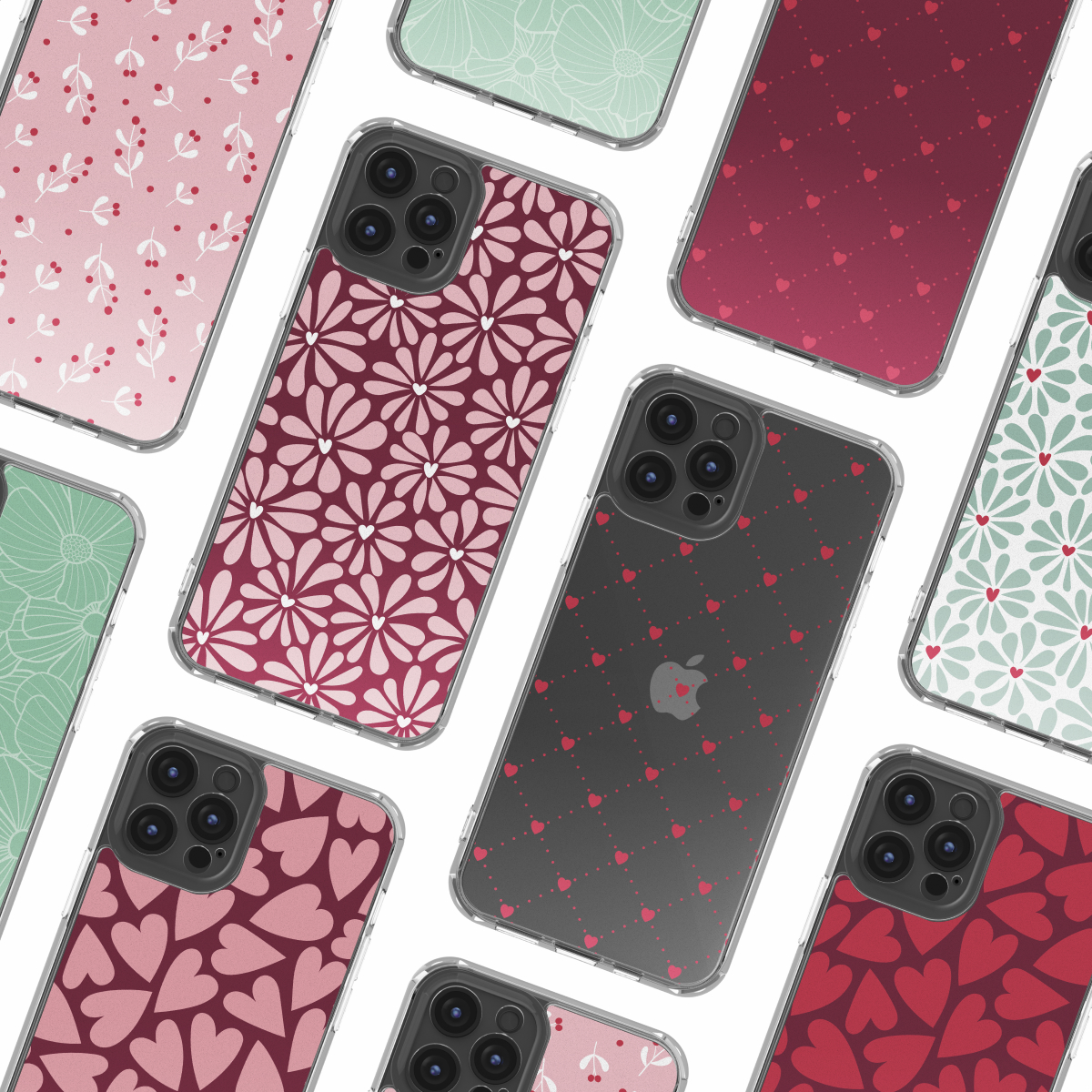Mehrere Smartphones mit verschiedenen Musterhüllen, darunter Blumen, Herzen und Punkte, liegen auf weißem Hintergrund.
