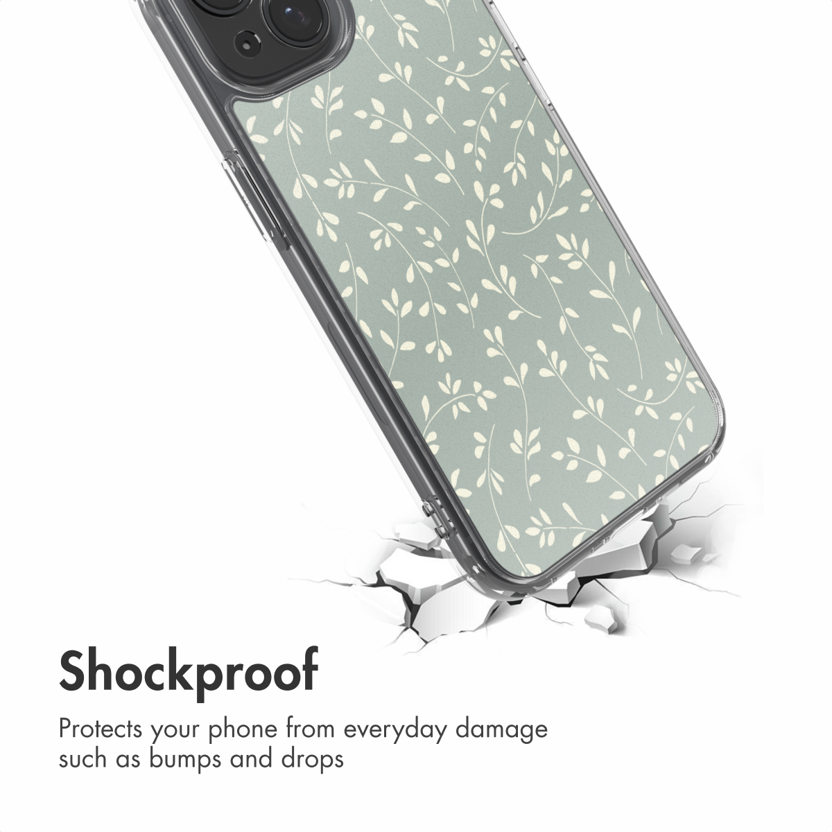 Een telefoonhoesje met groen bladmotief boven een gebarsten wit oppervlak met tekst Schokbestendig.