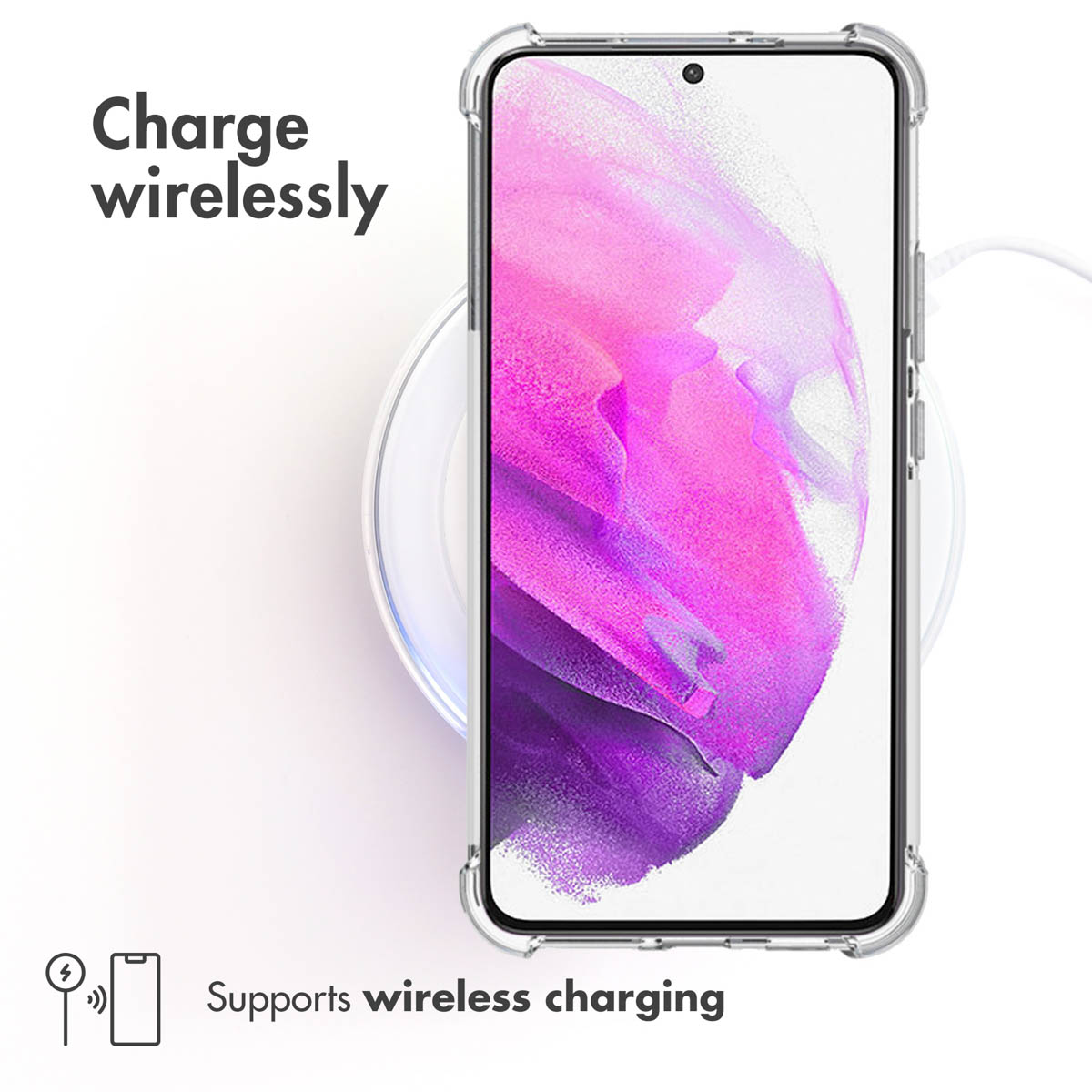 Un smartphone dans une coque transparente repose sur un chargeur sans fil blanc.