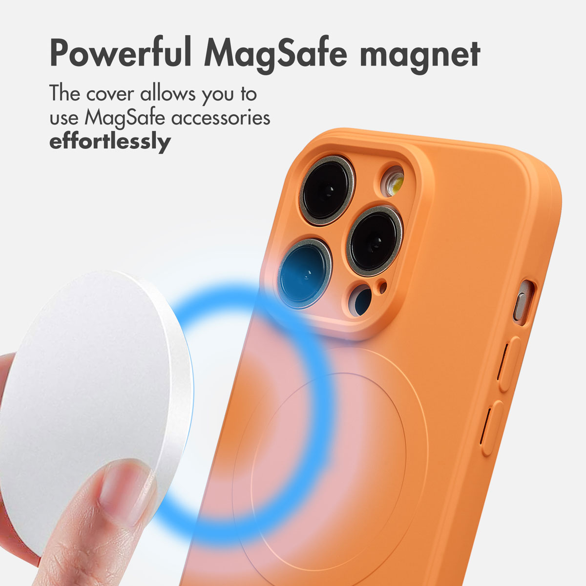 Una mano tiene un caricatore MagSafe vicino a una cover arancione per smartphone con anello magnetico.