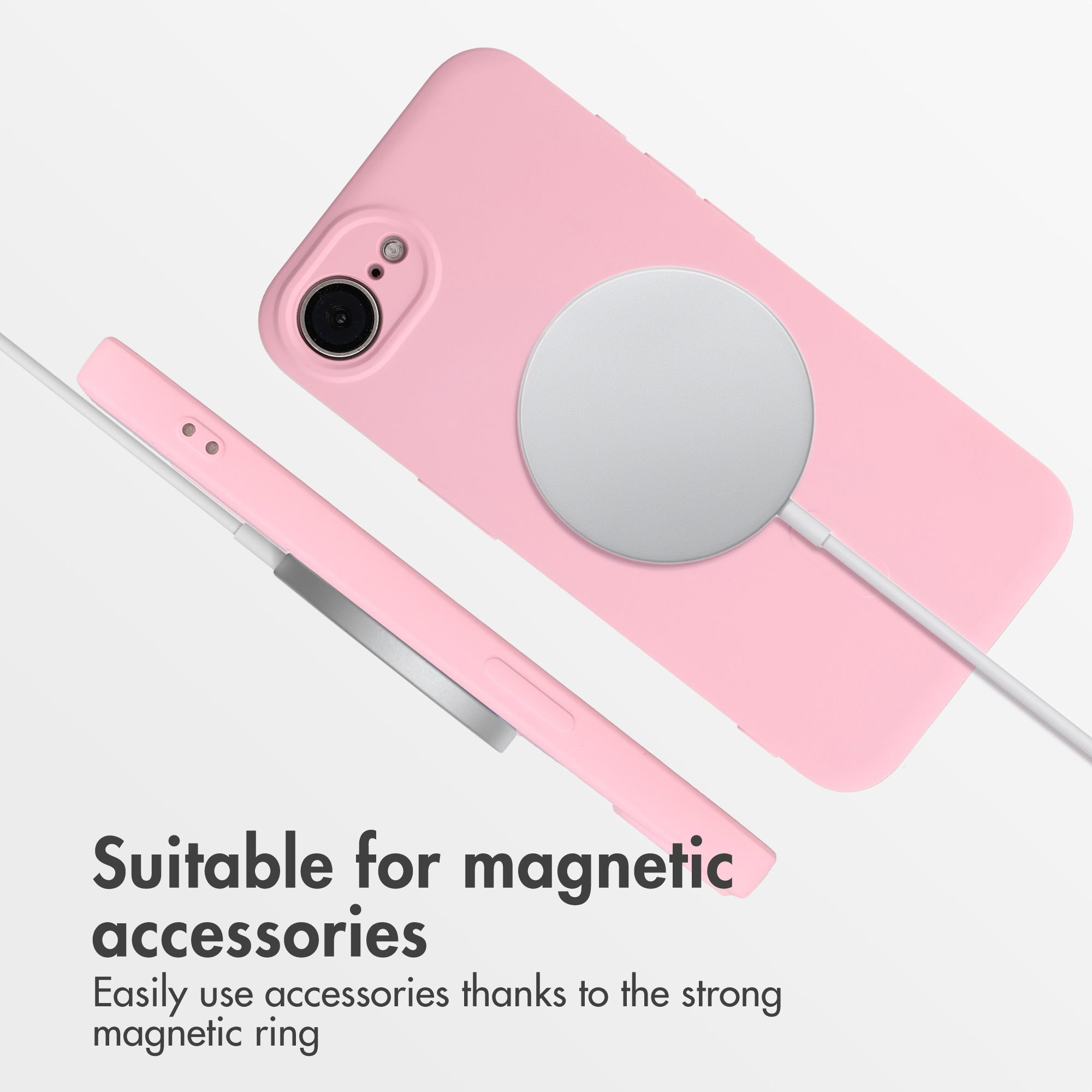 Coque de téléphone rose avec anneau magnétique argenté et câble de charge sur fond blanc.