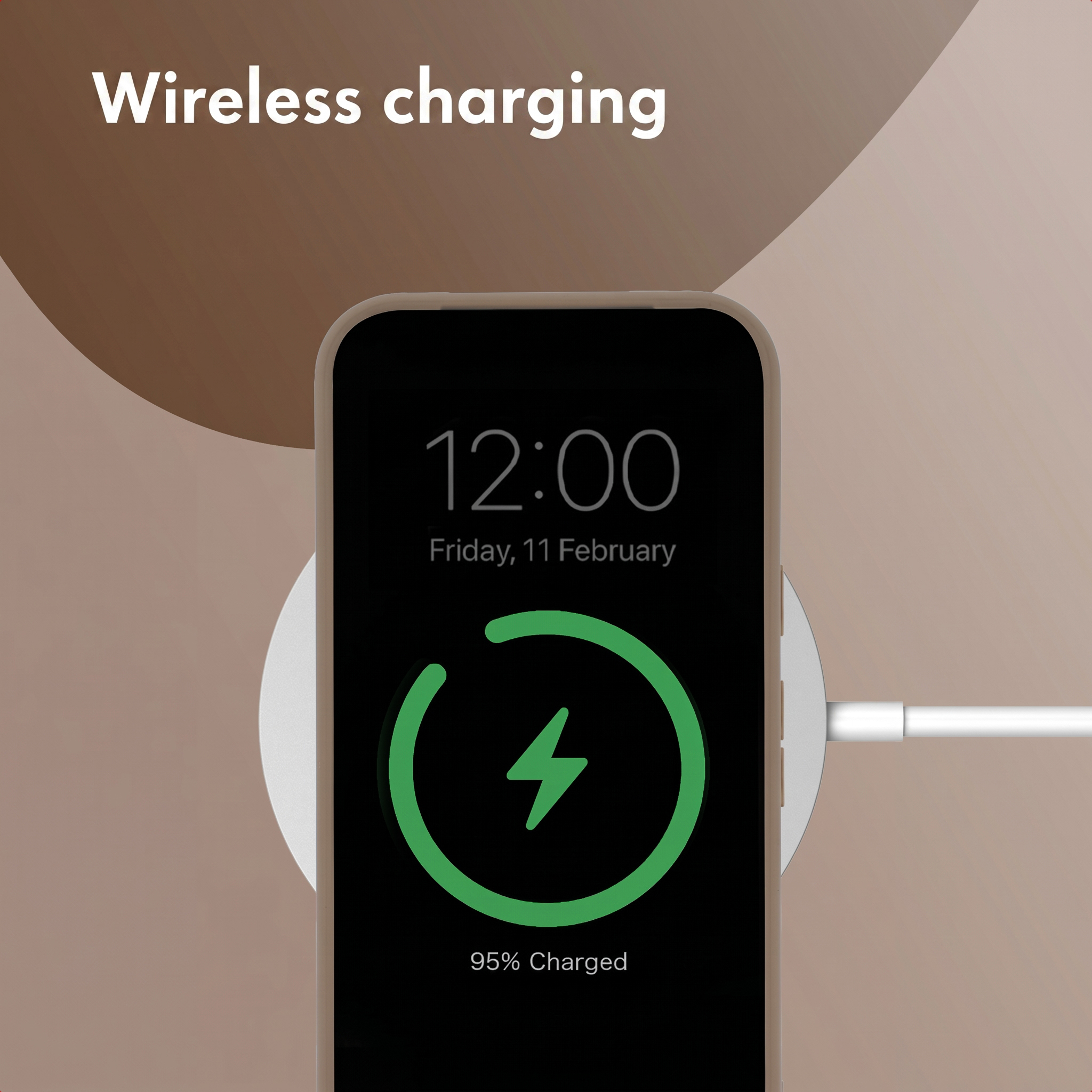 Smartphone on a white wireless charger showing a green charging icon.