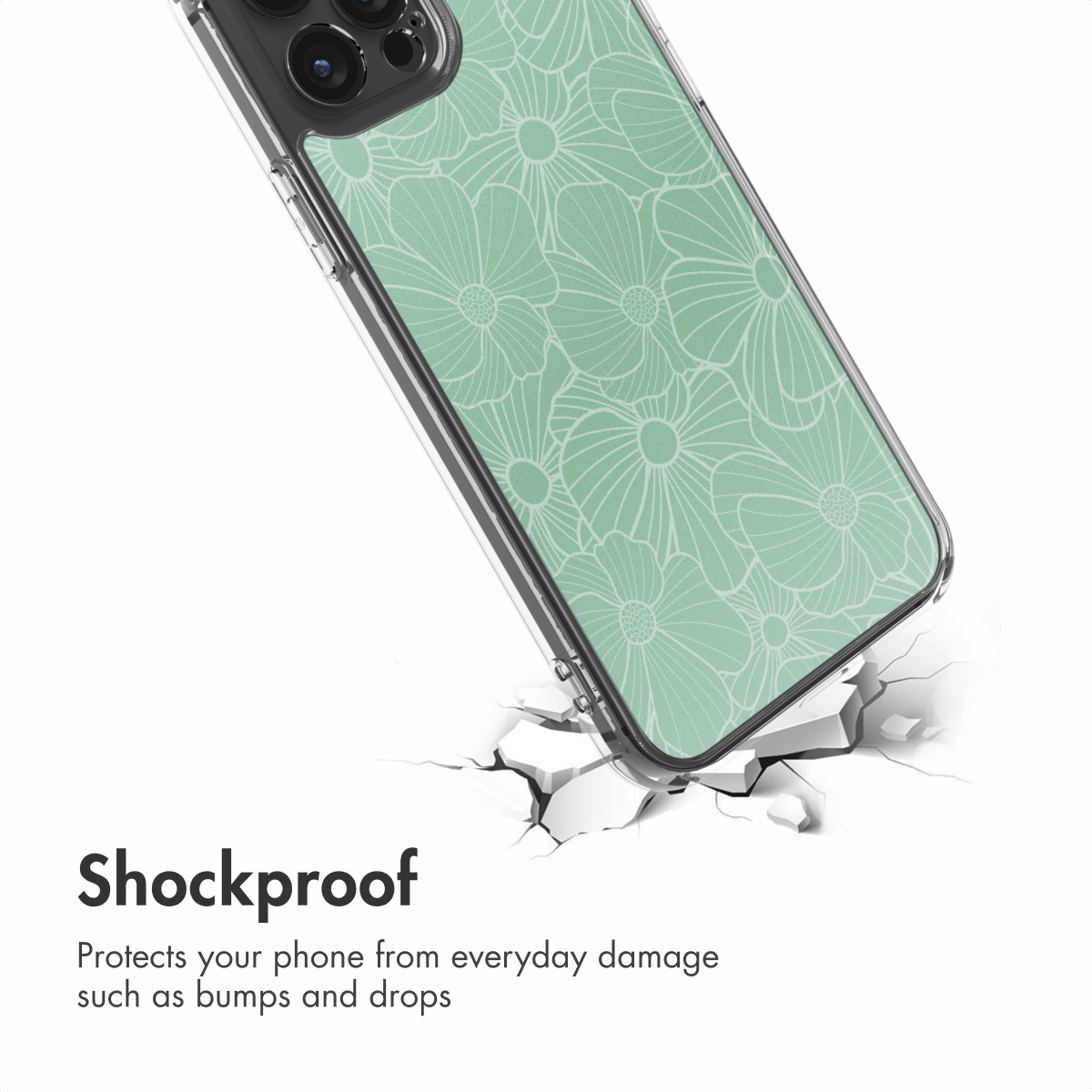 Una cover per telefono verde con motivo floreale su una superficie bianca incrinata.