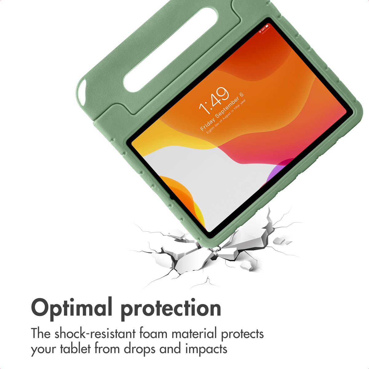 A tablet in a green foam protective case hovering over a cracked white ground.