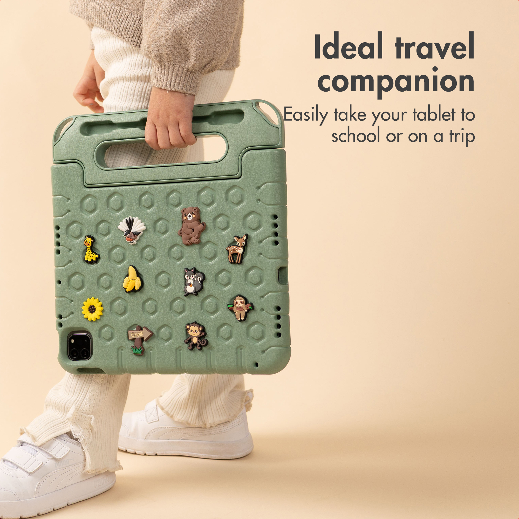 A child holds a green protective tablet case decorated with animal charms against a light background with text.