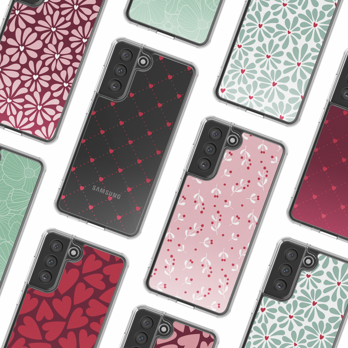 Varios teléfonos inteligentes con patrones coloridos como corazones, flores y bayas en una superficie blanca.