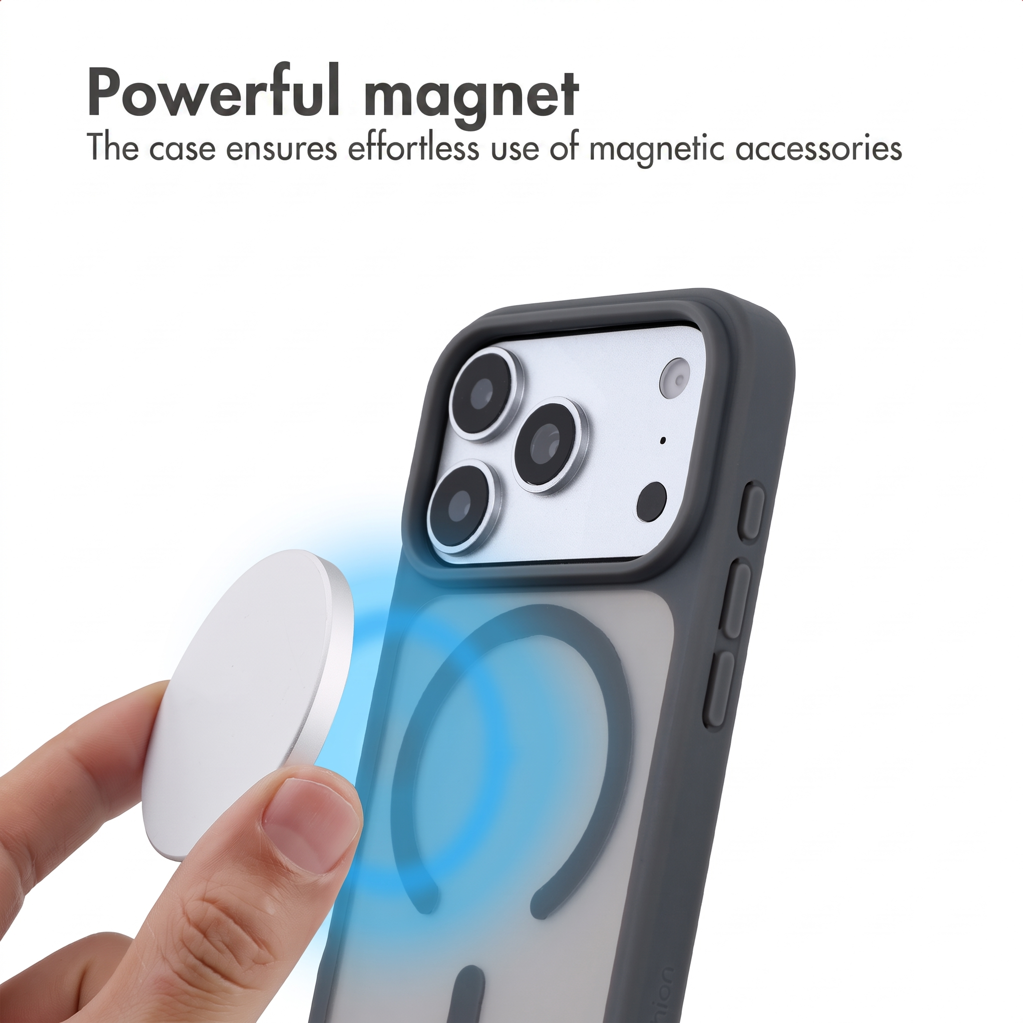 Una mano tiene un disco magnetico vicino a uno smartphone con cover scura.