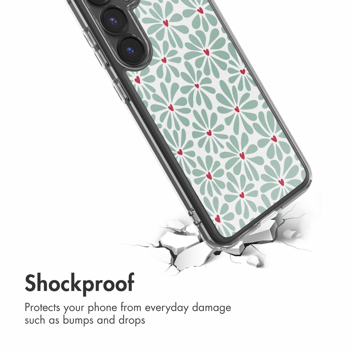 Un smartphone con funda transparente y flores verdes sobre una superficie blanca agrietada. Texto: A prueba de golpes.