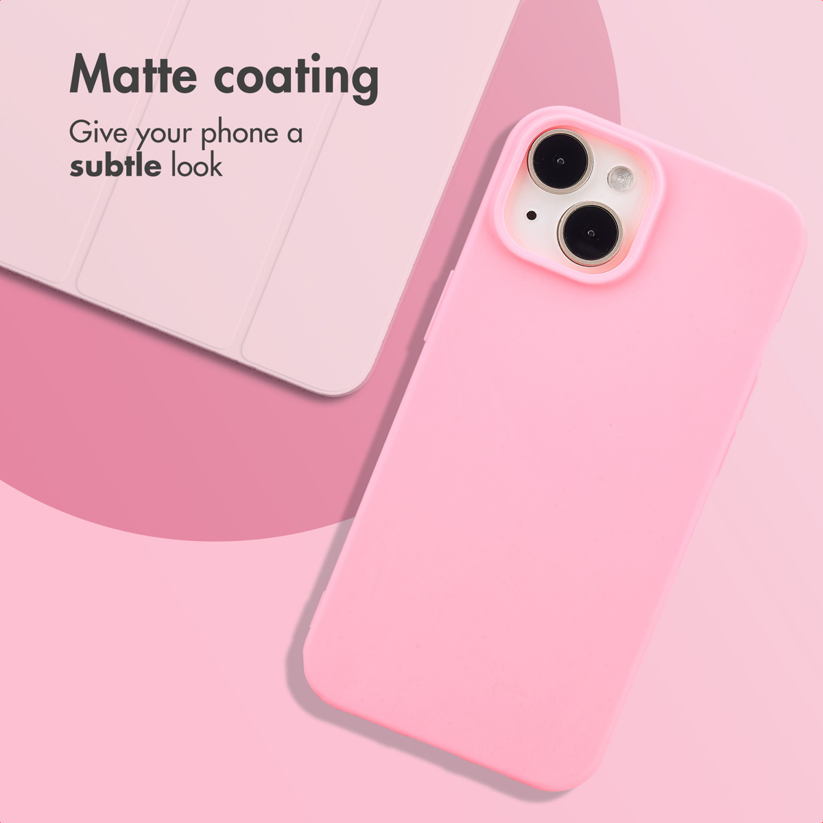 A pink smartphone in a matte protective case lies on a pink surface next to a pink tablet case.