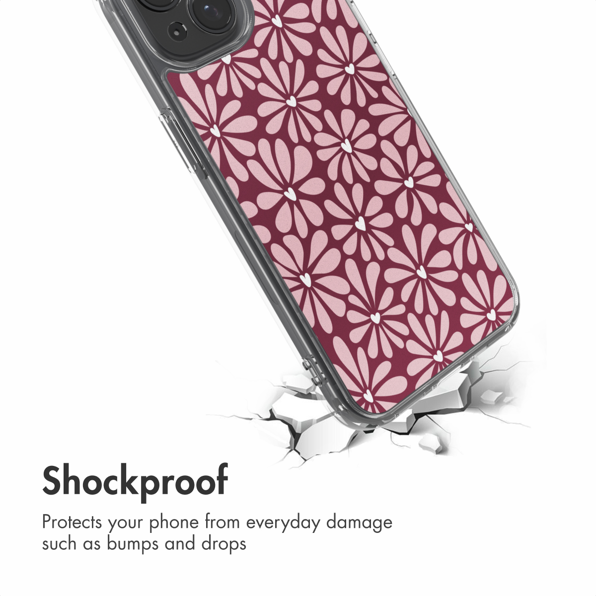 Een schokbestendig telefoonhoesje met roZE bloemen op bordeauxrode achtergrond boven een gebroken witte vloer.