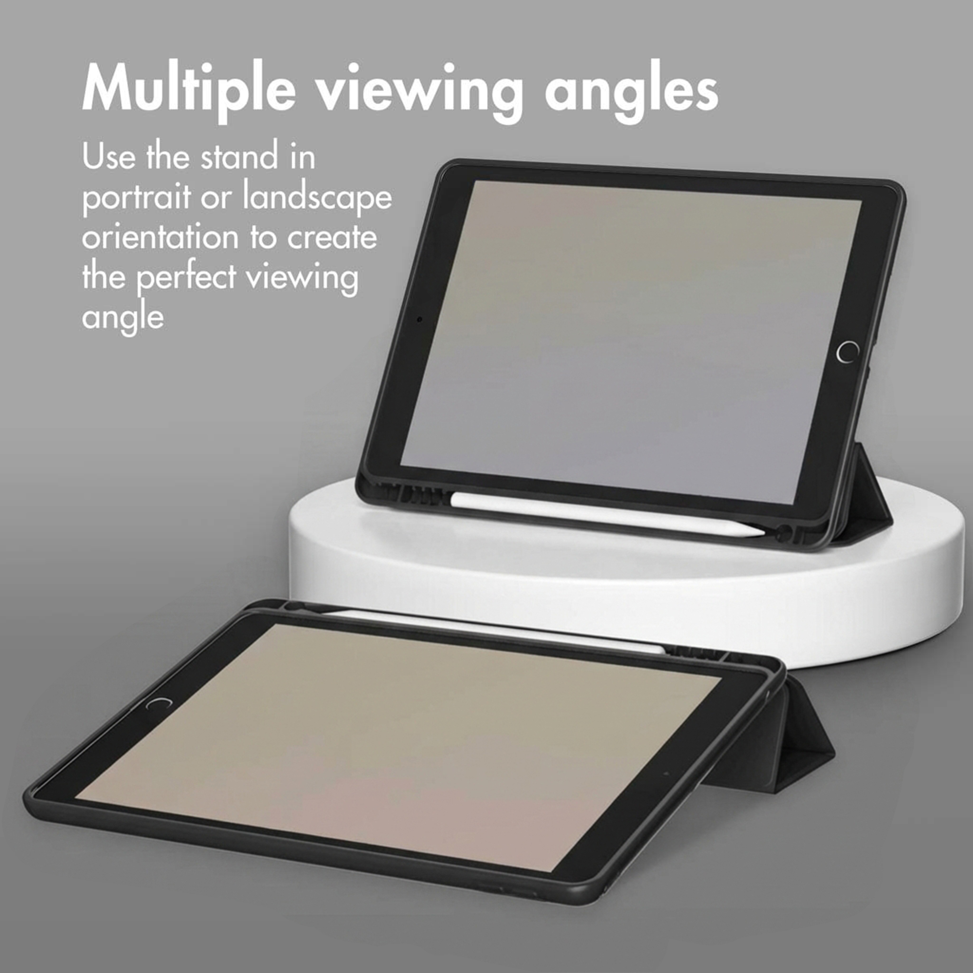 Two tablets in black cases on a gray background, one on a round podium.