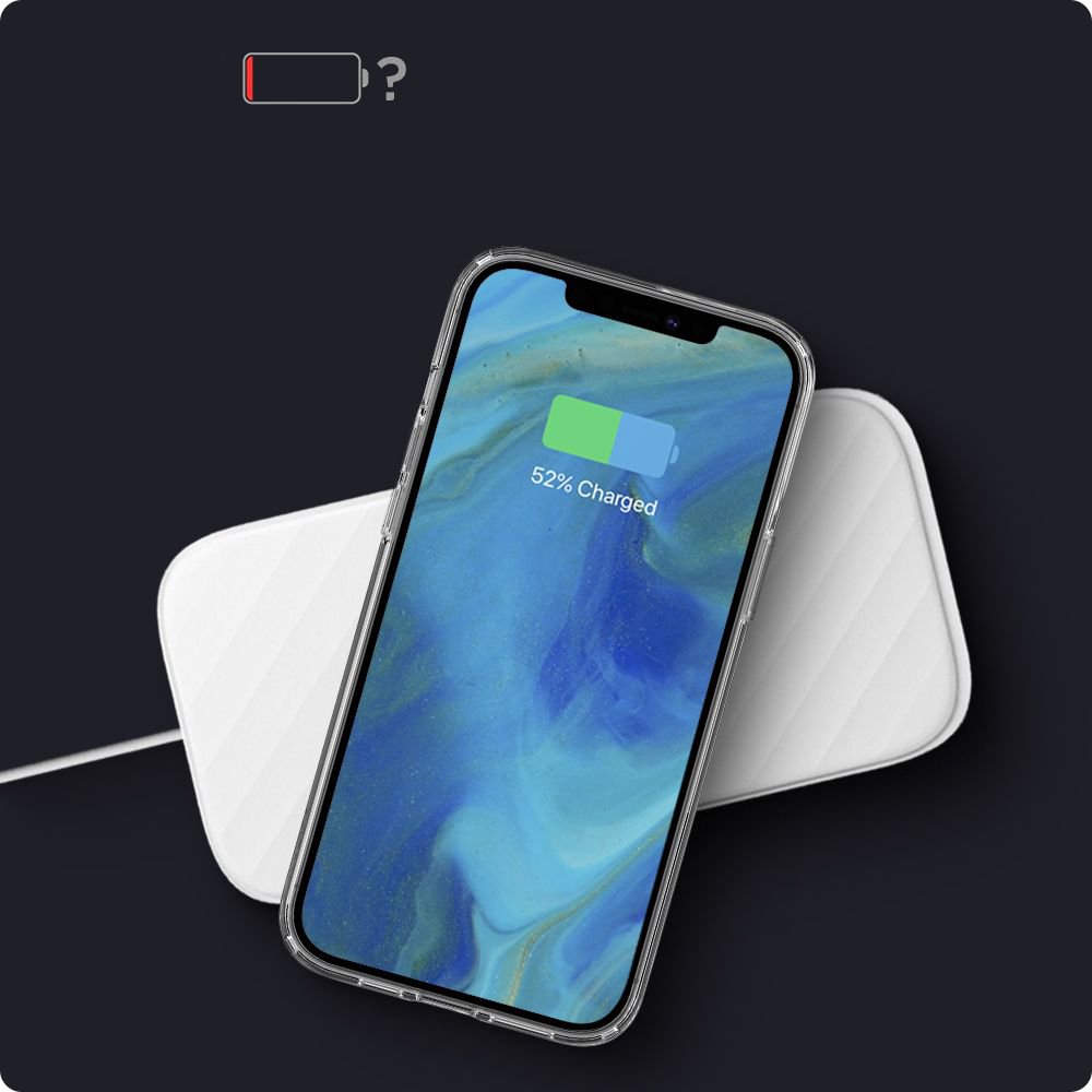 Smartfon ładuje się bezprzewodowo na białej podkładce na ciemnym tle.