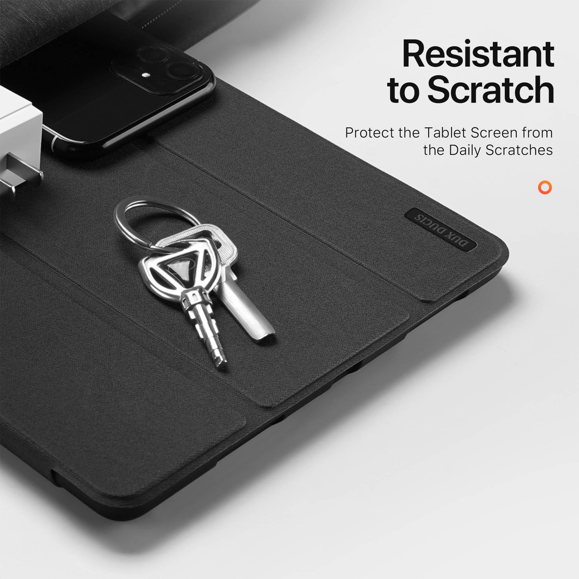 Custodia per tablet nera con chiavi e smartphone sopra, il testo indica resistenza ai graffi.