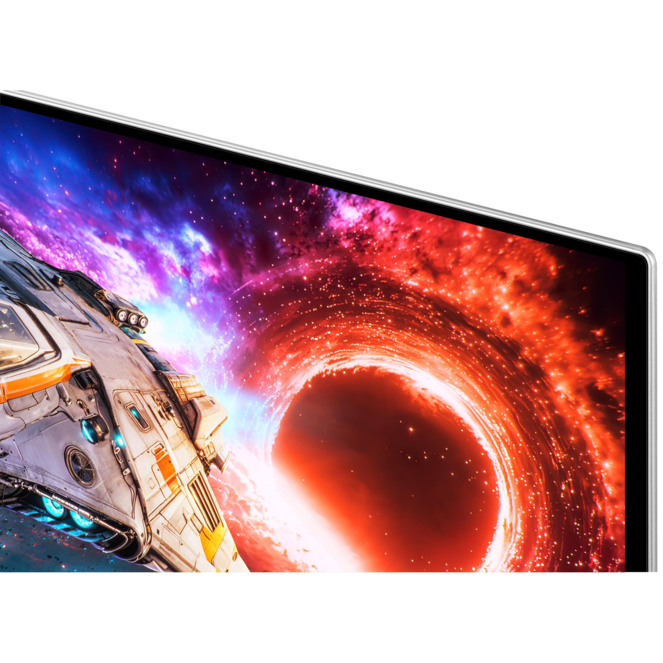 Una nave spaziale vola davanti a una nebulosa cosmica colorata su uno schermo televisivo.