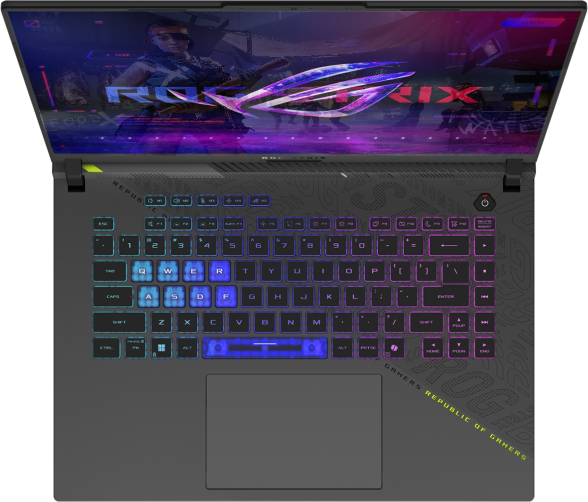 Arkadan aydınlatmalı klavyeye ve aksiyon temalı bir oyun gösteren ekrana sahip açık bir ROG Strix oyun dizüstü bilgisayarı.