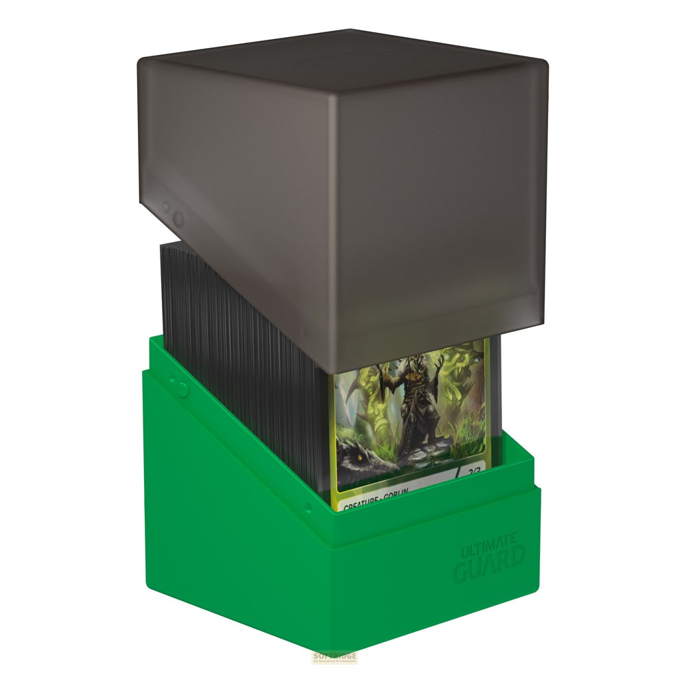 Une boîte de deck Ultimate Guard verte avec un couvercle gris et des cartes à collectionner.