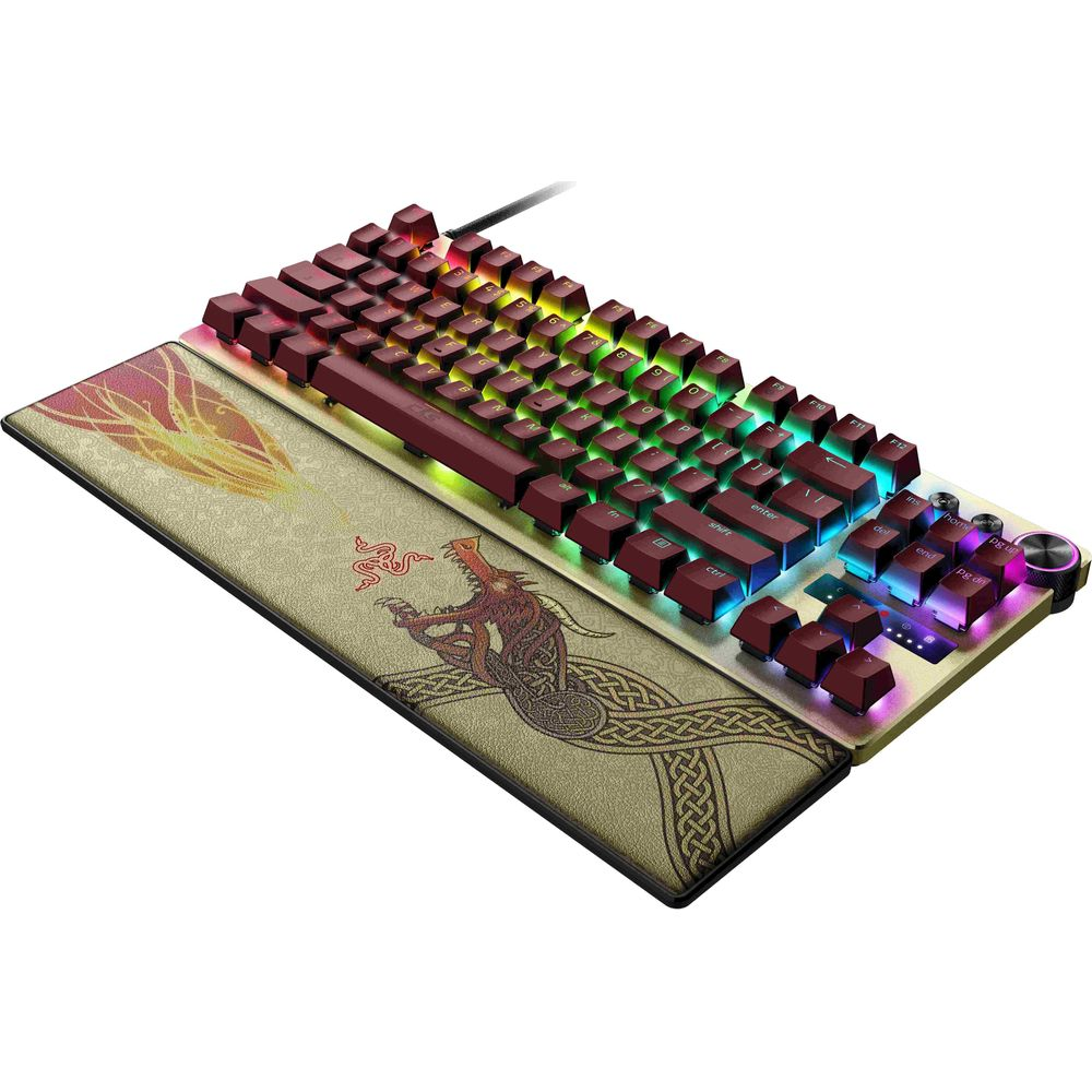 Un teclado mecánico para juegos con teclas rojas, iluminación RGB y un reposamuñecas con diseño de dragón.