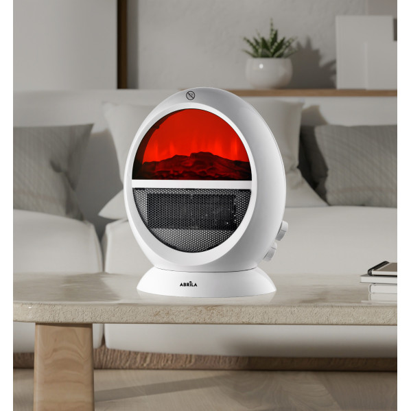 Un calefactor eléctrico redondo y blanco con efecto de llama roja sobre una mesa en una habitación luminosa.