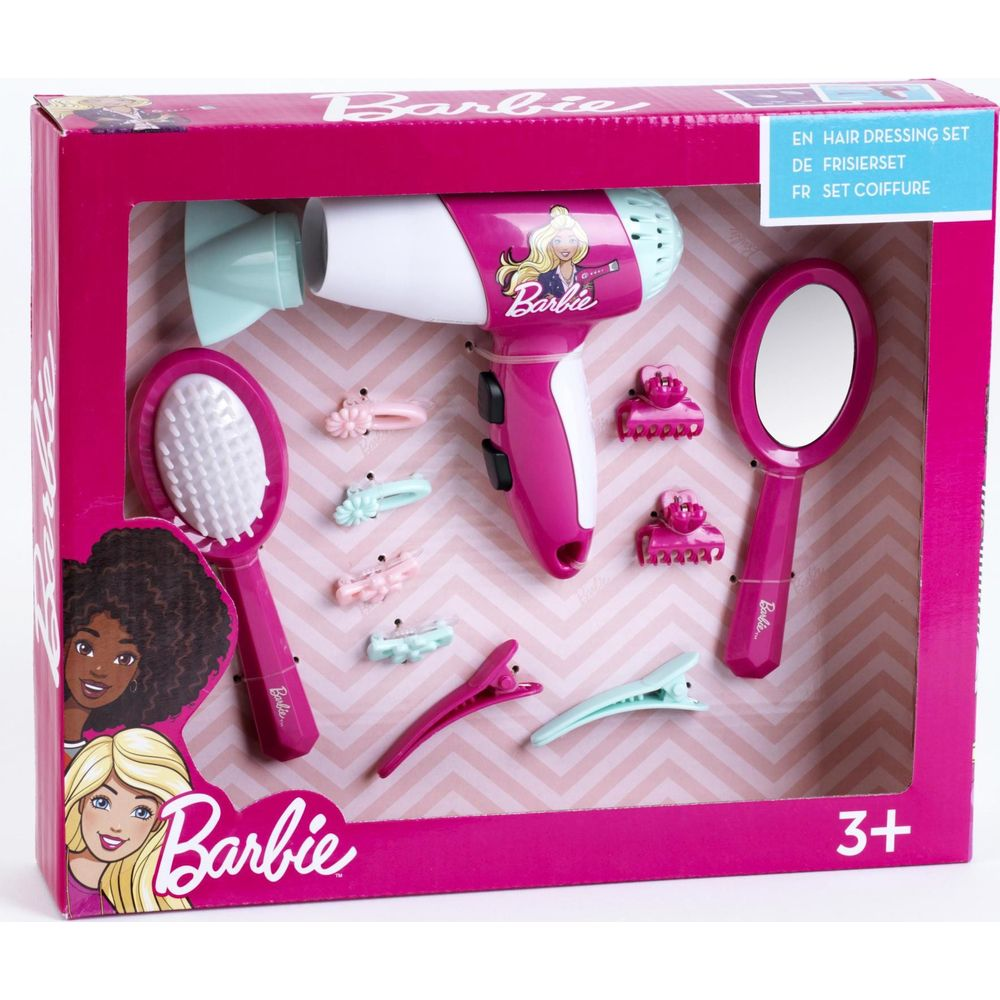 Ein pinkfarbenes Barbie-Frisierset in einer Box mit einem Spielzeug-Föhn, Haarbürste, Handspiegel und Clips.