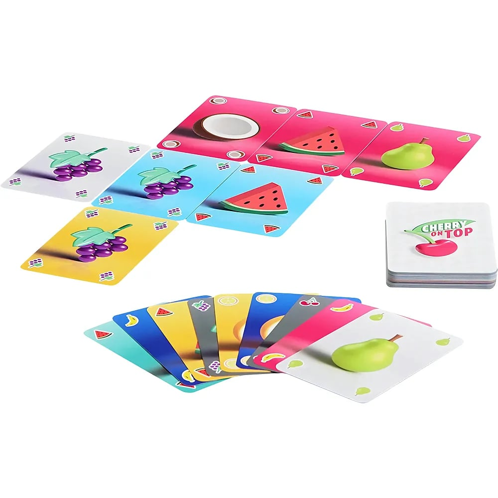 Jeu de cartes coloré avec des fruits comme du raisin, de la pastèque et de la poire disposés sur une table.