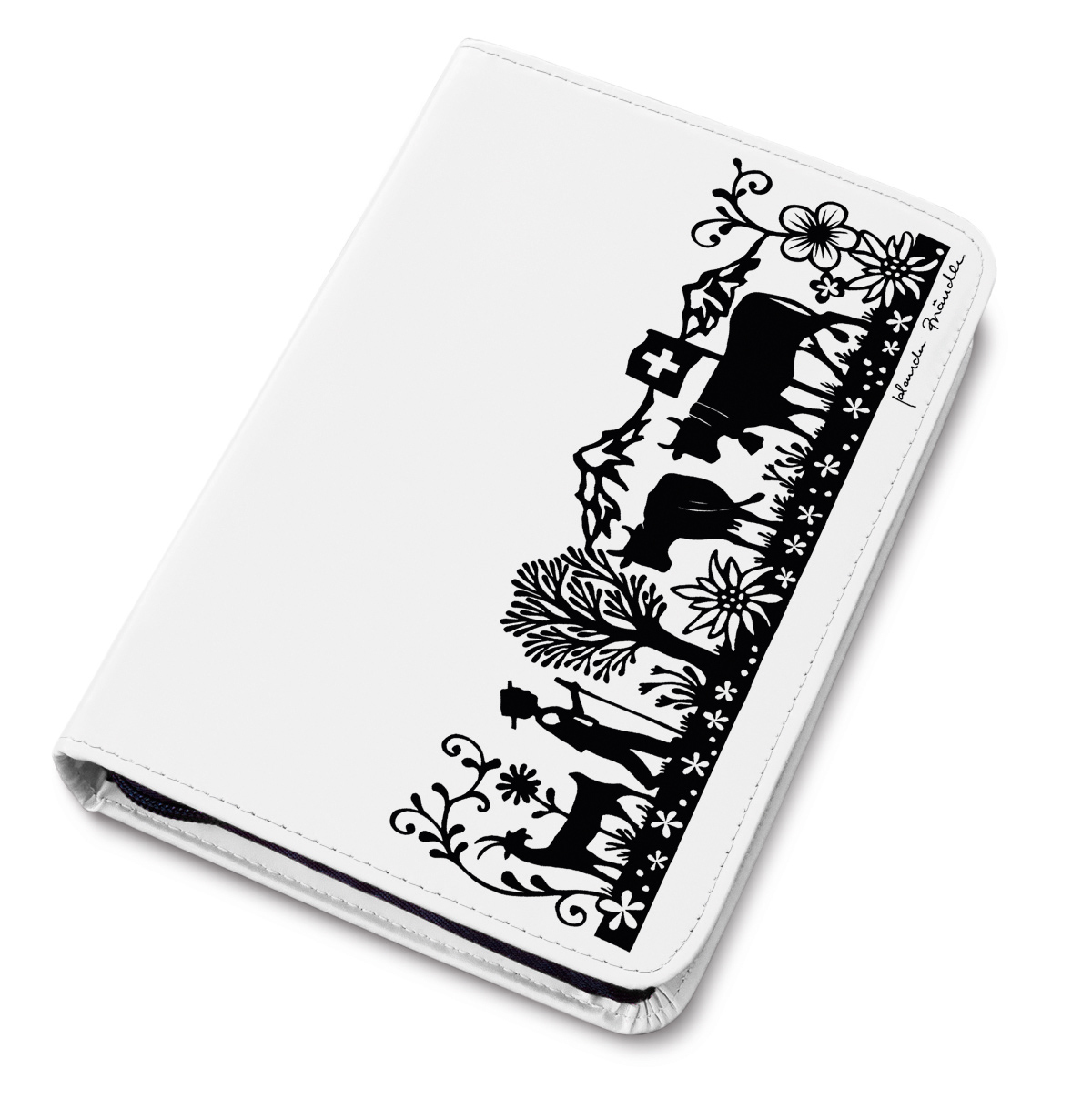 Un étui blanc avec un motif de papier découpé noir représentant une scène rurale avec des vaches, des montagnes et des fleurs.