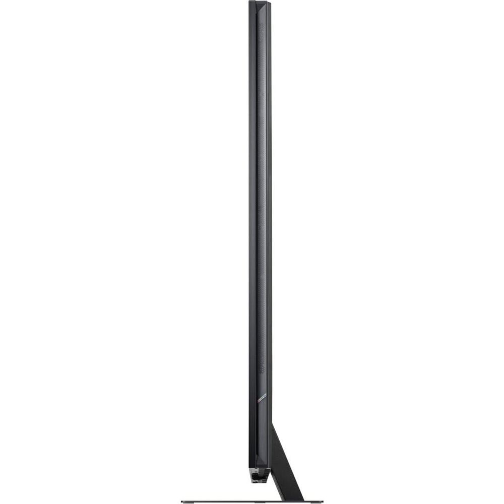 Vue de profil d'une télévision noire fine posée sur un socle rectangulaire sombre sur fond blanc.
