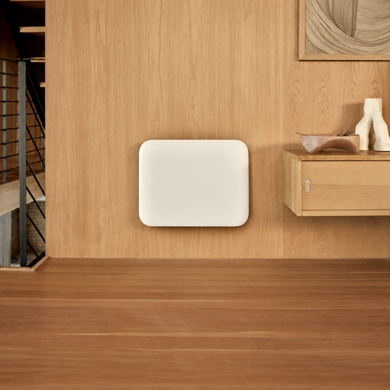 Un termosifone piatto bianco su una parete in legno sopra il pavimento.