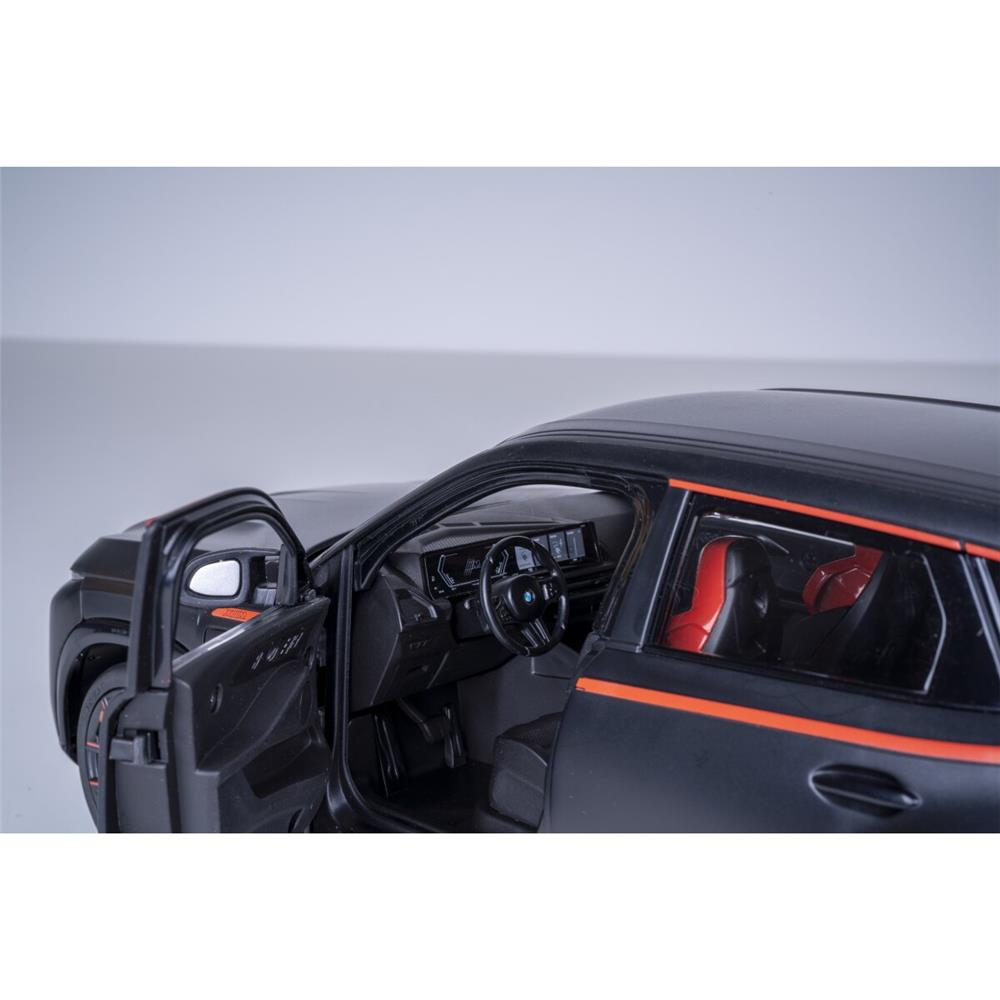 Ein schwarzes Spielzeugauto mit orangen Streifen, offenen Türen und rotem Innenraum.
