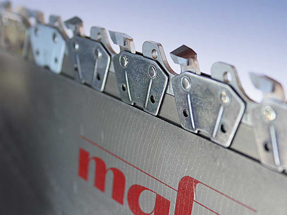 Nahaufnahme einer Metallkettensäge mit scharfen Zähnen und roter Markenaufschrift auf der Klinge.