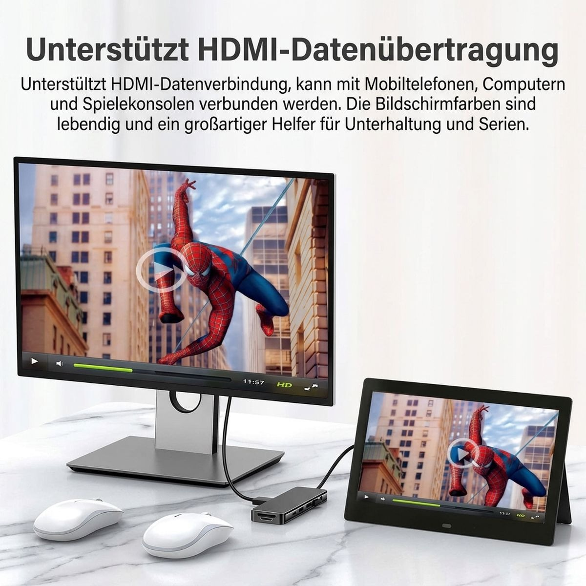 Ein Monitor und ein Tablet zeigen eine Filmszene, verbunden über einen HDMI-Hub, auf einem weißen Schreibtisch.