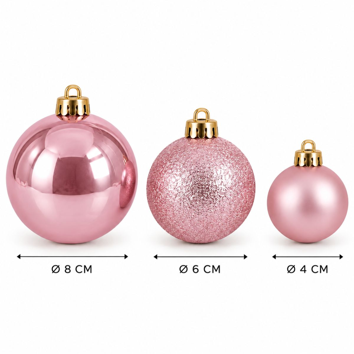 Trois boules de Noël roses avec des capuchons dorés de 8 cm, 6 cm et 4 cm sur fond blanc.