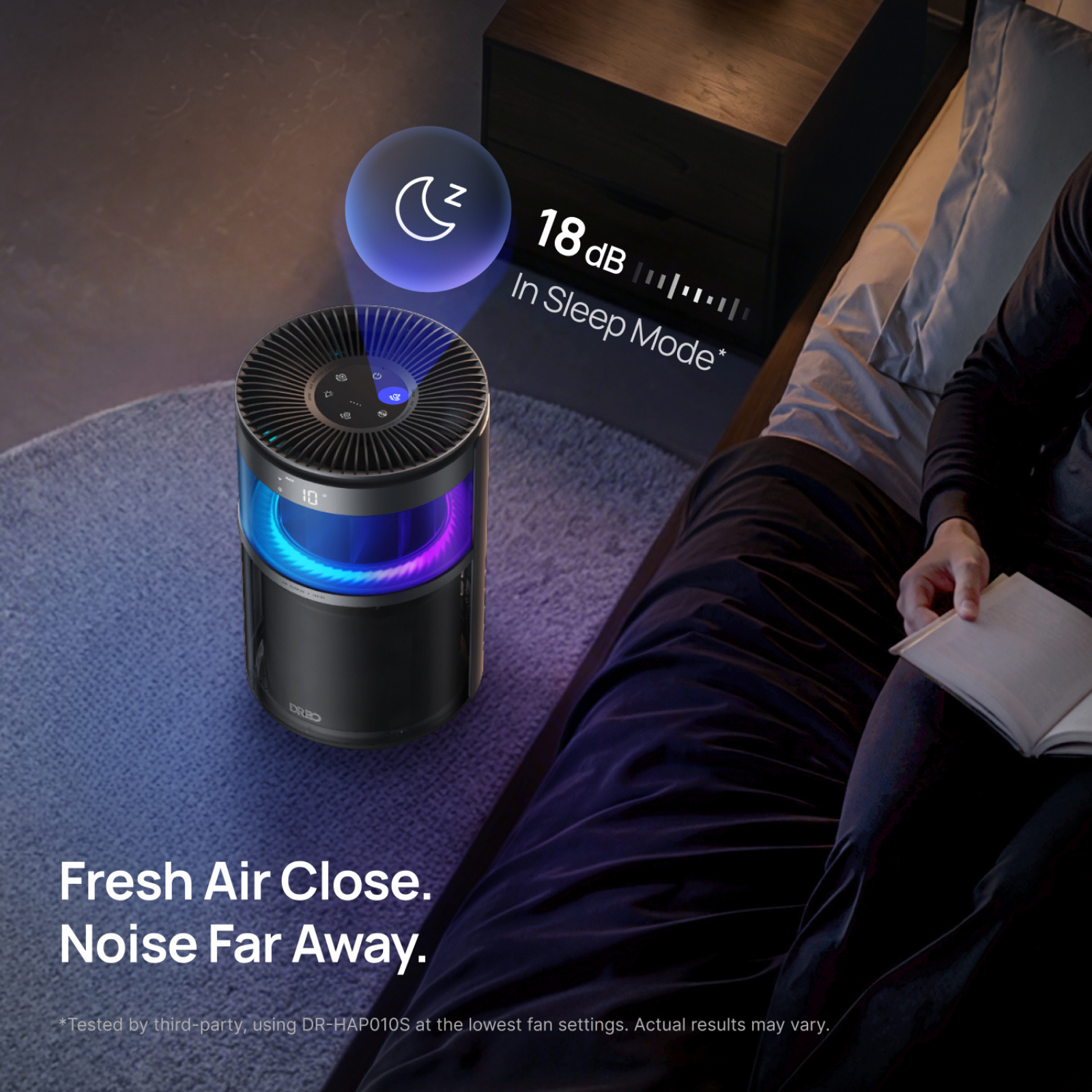 A quiet air purifier stands beside a bed while someone reads. Text shows 18 dB in sleep mode.
